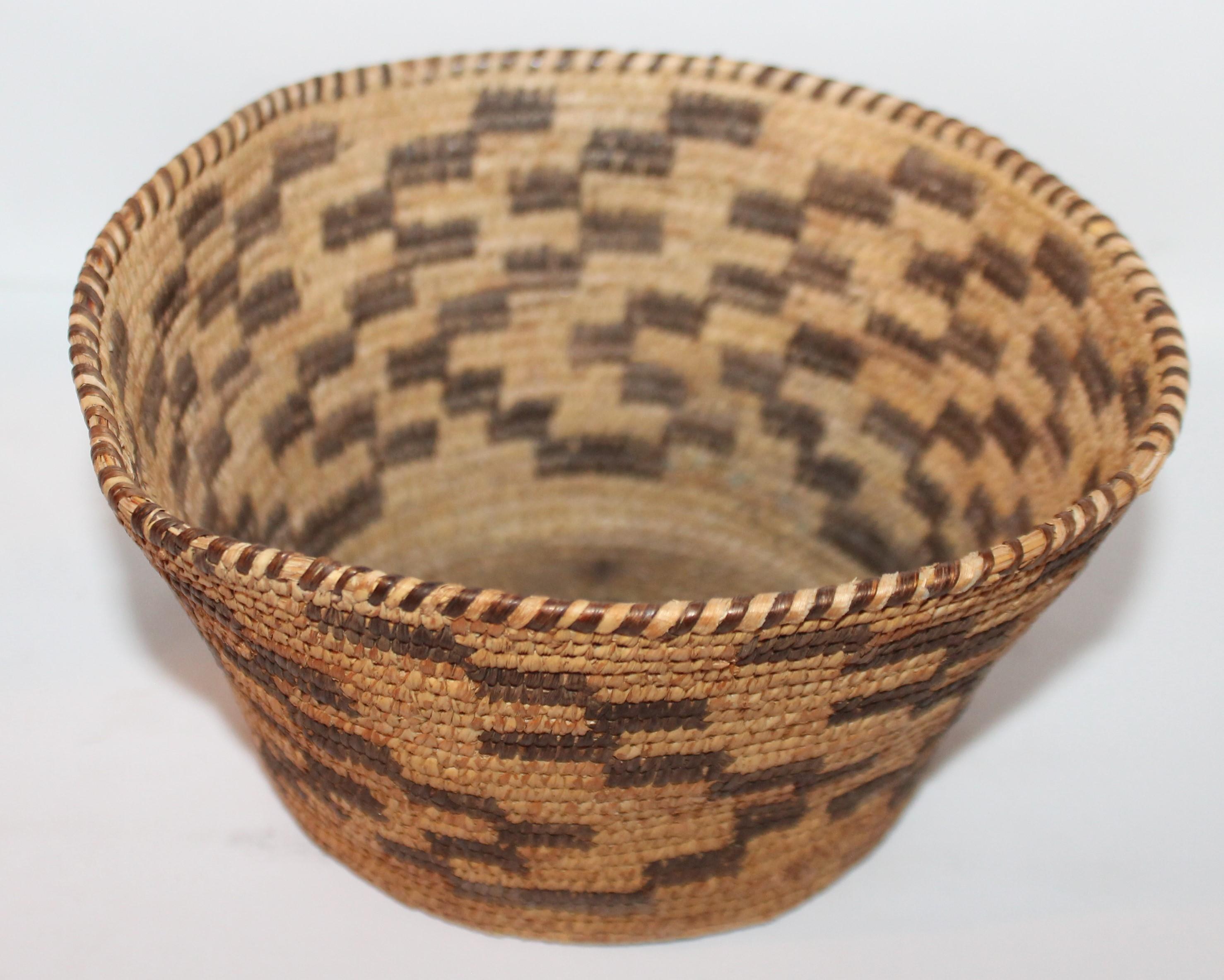 This fantastic American Indian basket is in fine condition and has an unusual shape to it. Great graphics!