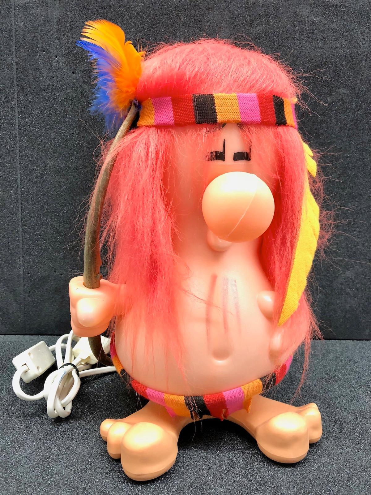 Beautiful pop culture table lamp in the form of a comic figure style American Indian. This light requires one European E14 candelabra bulb, up to 25 watts. It comes in the original old plastic box (Lid of the box is missing). It is made of plastic