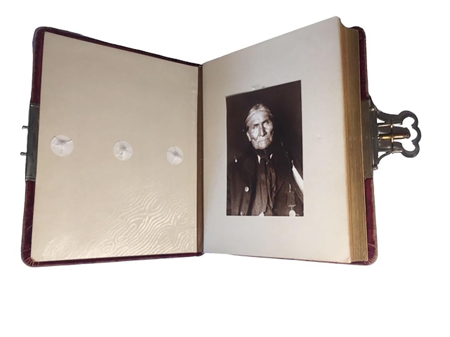 A late 19th century to circa 1900 red velvet photo book with twenty seven old photos of American Indians. The engraved silver ornament on front was added at a later date to give a North American Indian feel.