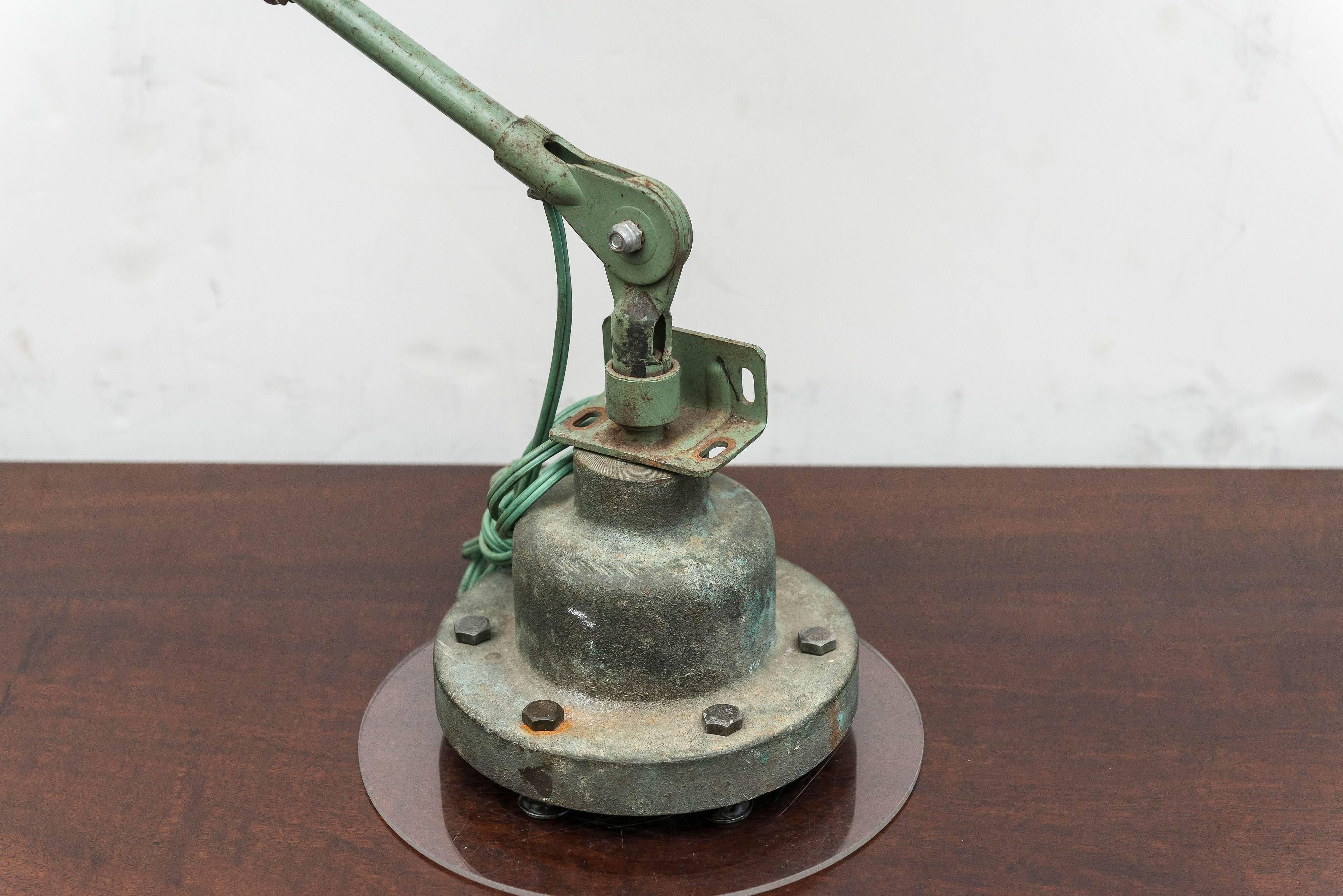 American Industrial lamp. Steel and old paint on a solid bronze base. Possible U S (no labels) government issue, circa 1940-1950.

The height and reach are adjustable. Well used surface is unrestored. Older wiring , socket and switch tested and
