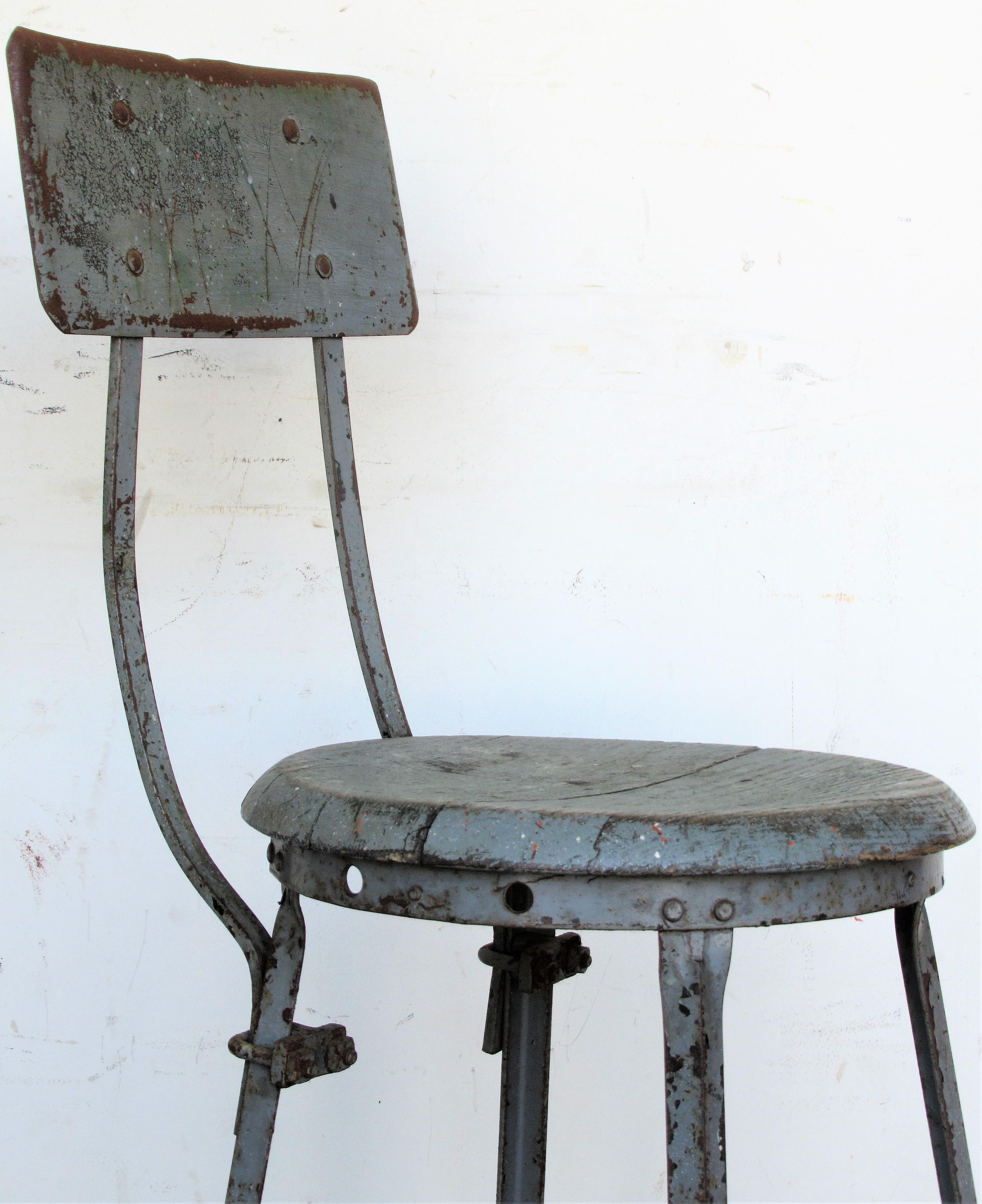 American industrial iron stool with shaped oak wood seat in the best beautifully aged overall old worn pale silver gray blue painted surface, Circa 1930 - 1940. Look at all pictures and read condition report in comment. Section.