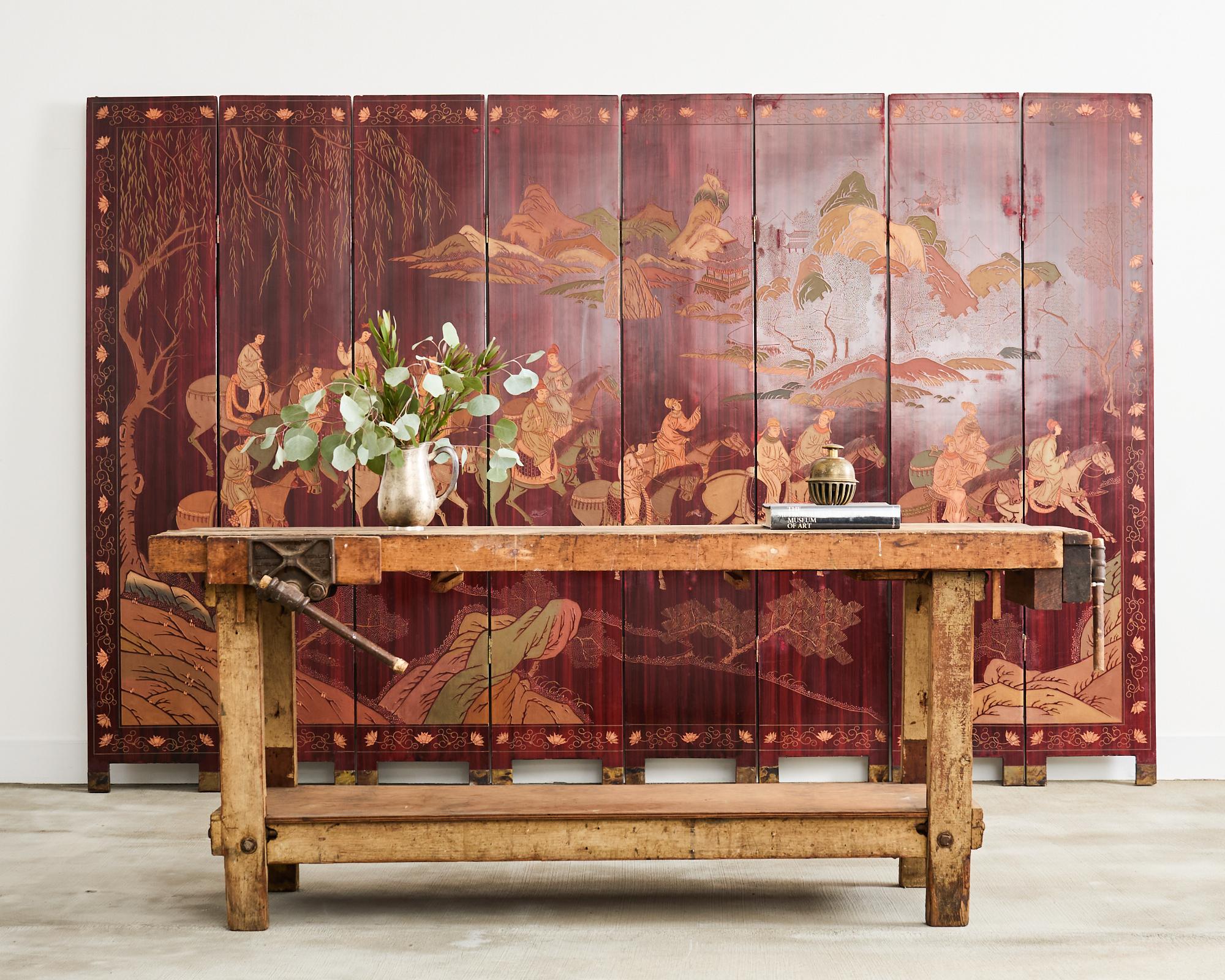 Beautifully aged and weathered American industrial style carpenters work bench table or etabli. The hardwood bench features 2 iron vices from Columbian Vice Co. in Cleveland, Ohio. The two-tier design has a bottom shelf with a pine top. The bench is