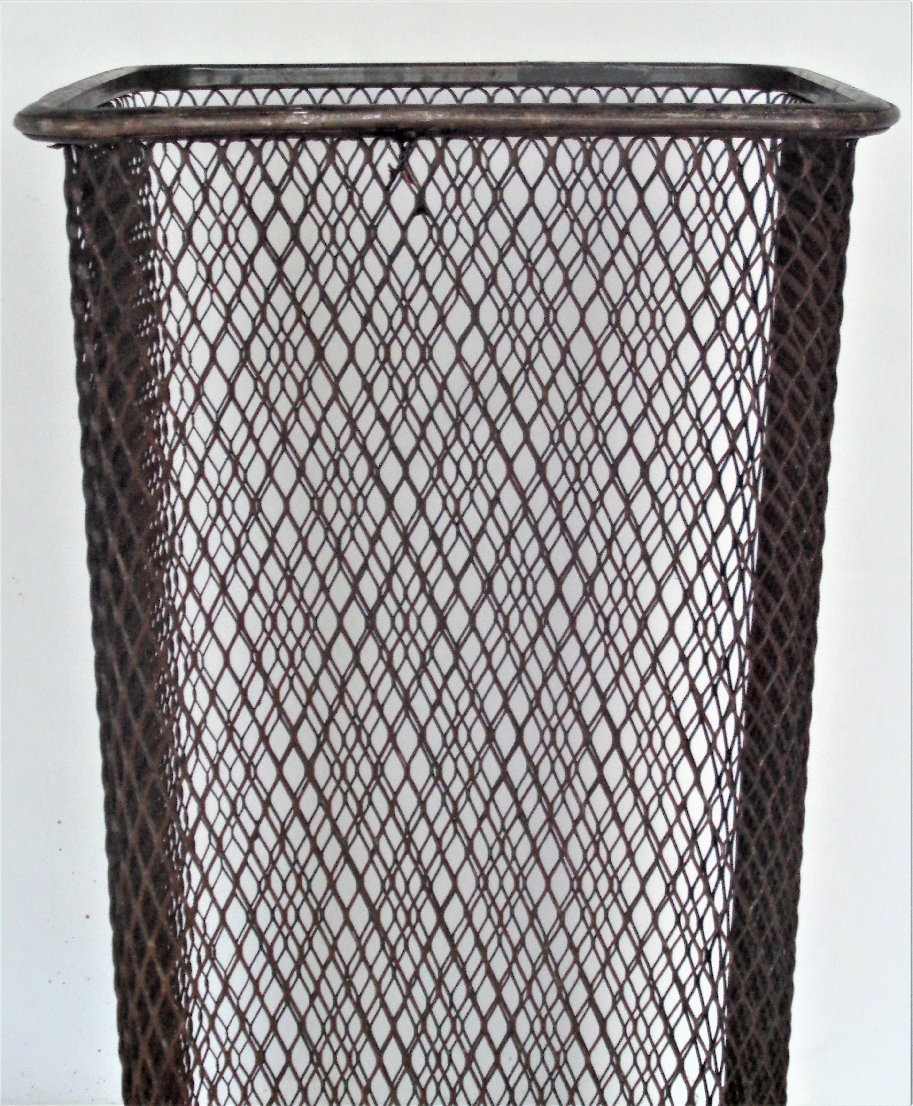 American industrial tall metal wire waste basket in nicely aged all original vintage condition. Measures 24 inches high by 13 inches wide across top x 17 inches diagonally across top. Circa 1930's -.This is a very nice one. Look at all pictures and