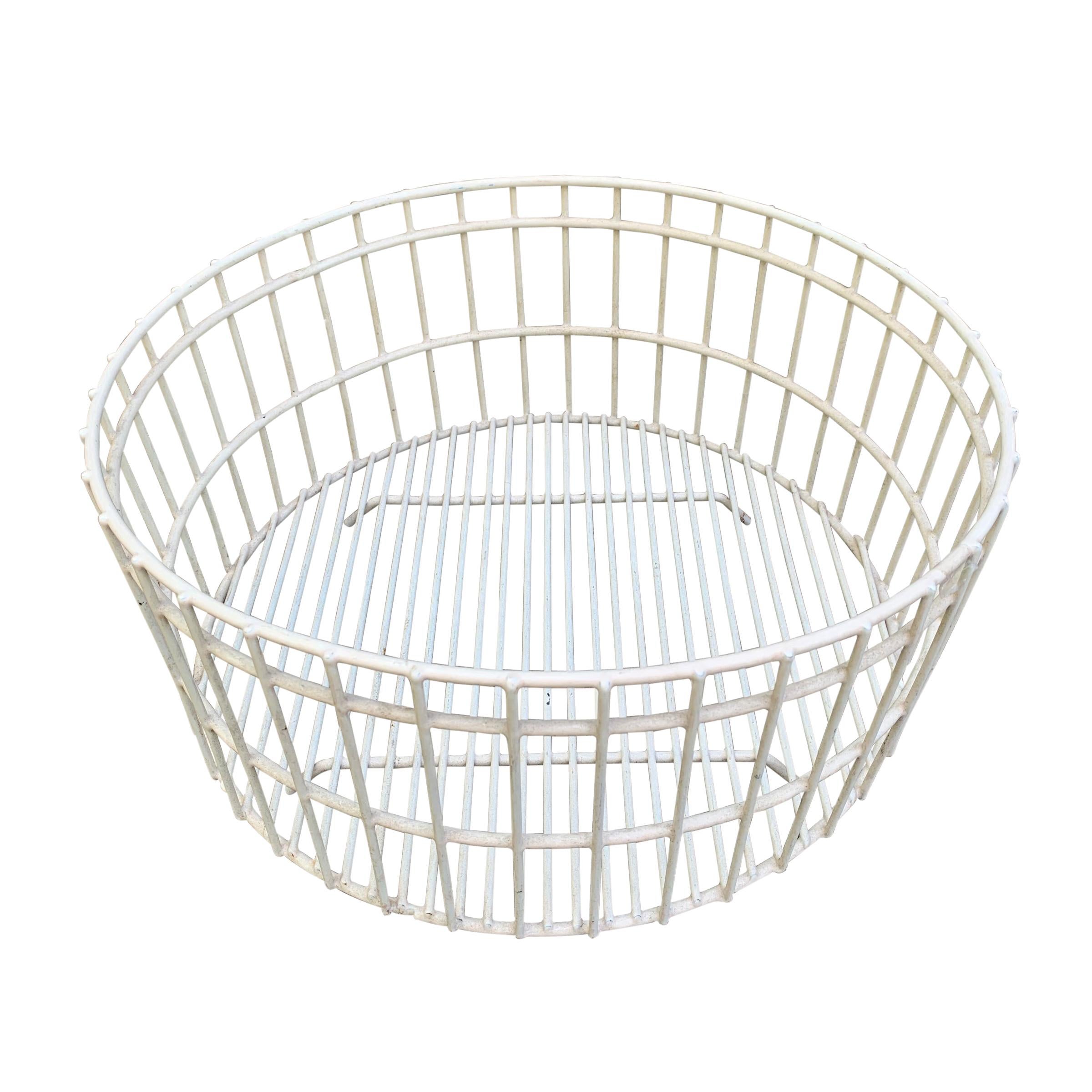 A cool mid-20th century American industrial wire basket with a white plastic coating. Perfect for your fruit on the counter top of your Mid-Century Modern kitchen.