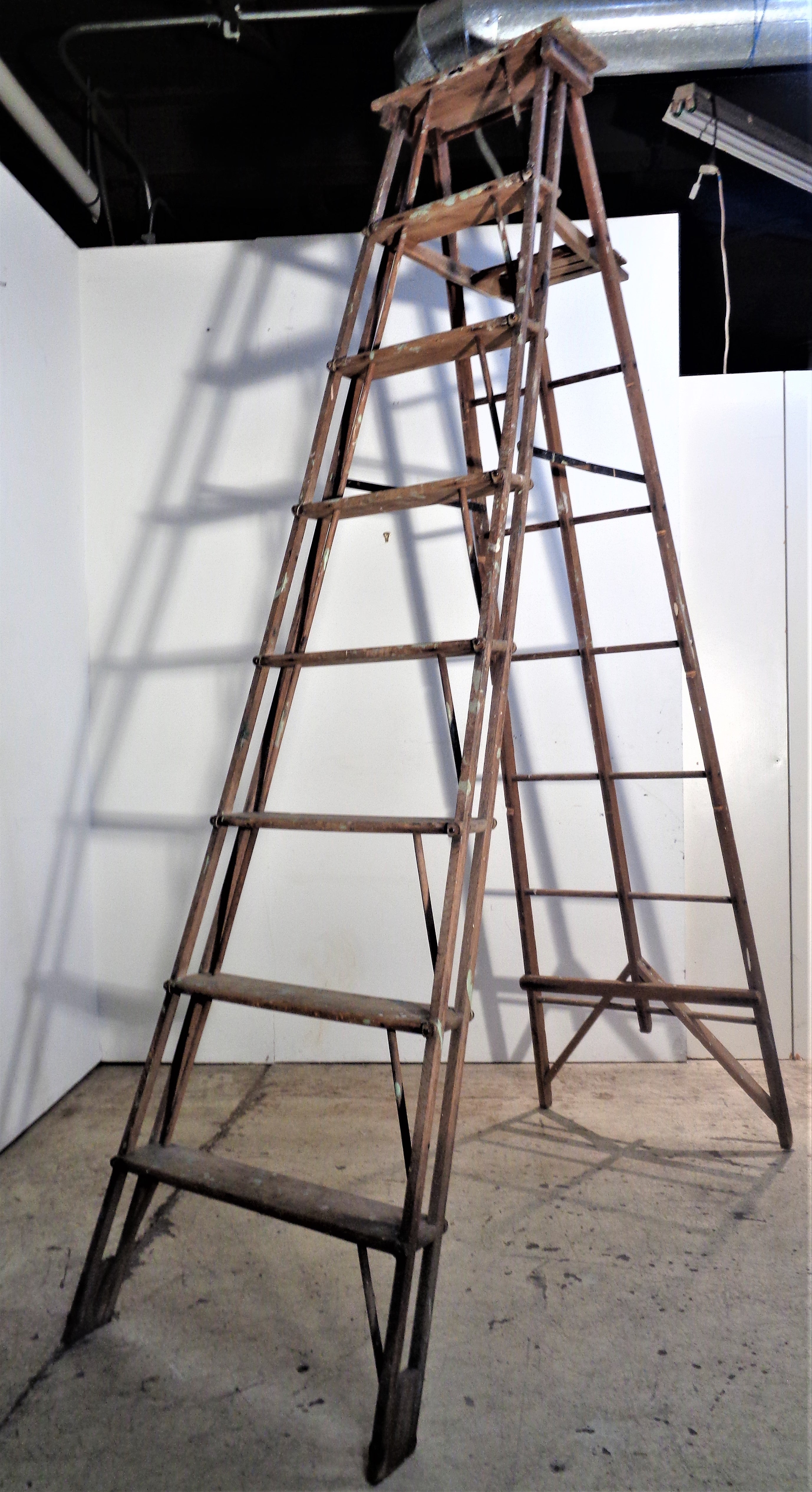 American industrial work ladder with great architectonic form and beautifully aged color to wood and metal fittings. Measures fully extended open as shown in pictures - 90