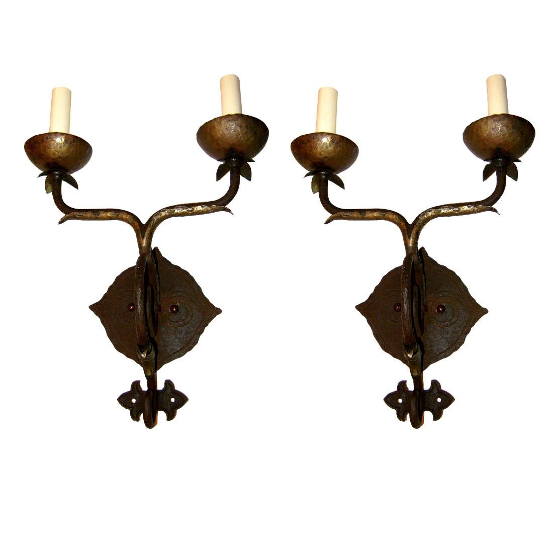 Pair of 1930's American hammered iron arts and crafts two arm sconces.

Measurements:
Height: 8.5