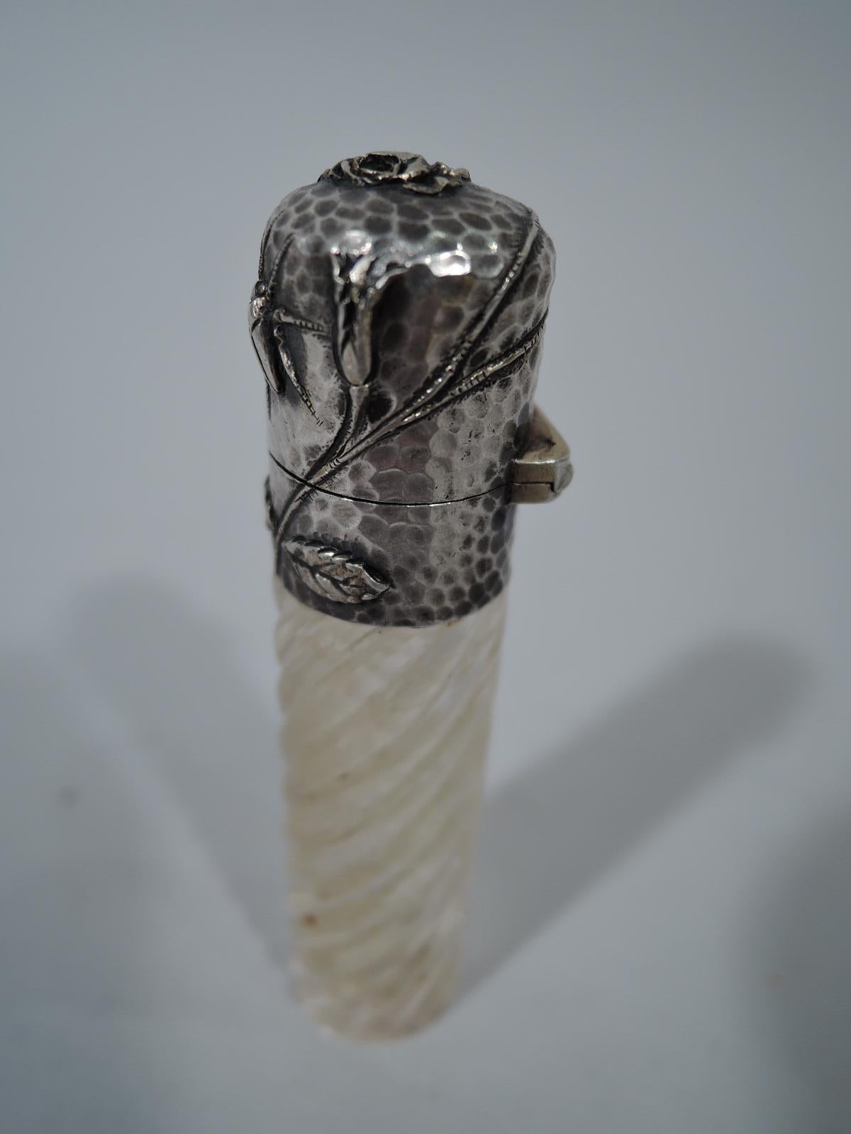 American applied sterling silver perfume vial, ca 1880. Clear glass cylinder with twisted fluting. Sterling silver collar and hinged cover with tendril, flower, and insect on hand-hammered ground; gilt interior. Unmarked.