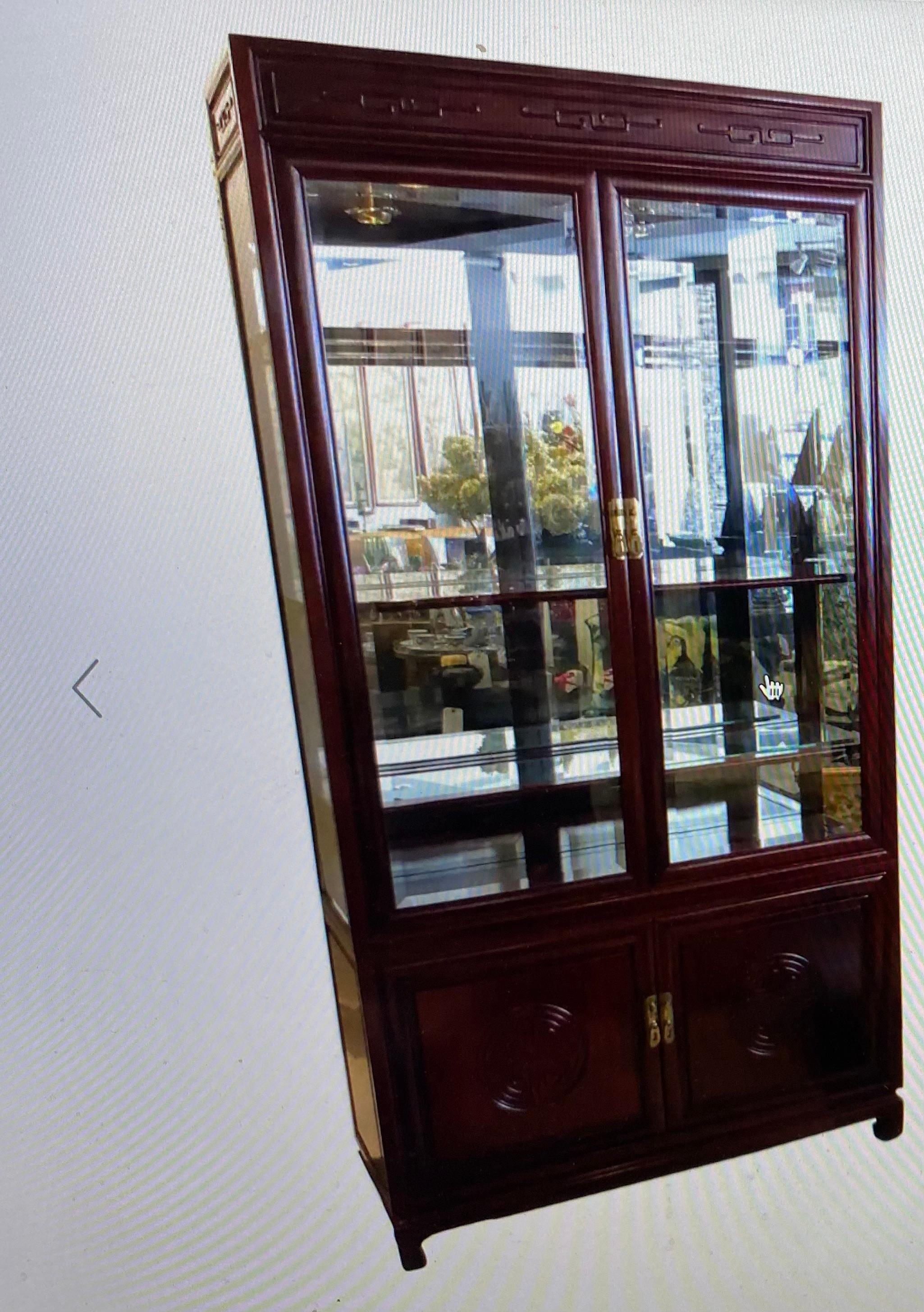 This American John Widdicomb Chinese style DISPLAY CABINET is in 2 sections top and bottom Made of mahogany mirrored back three (mahogany frame glass inset) shelves to the top, lighting also in the top, pair of doors to the bottom and one shelf It