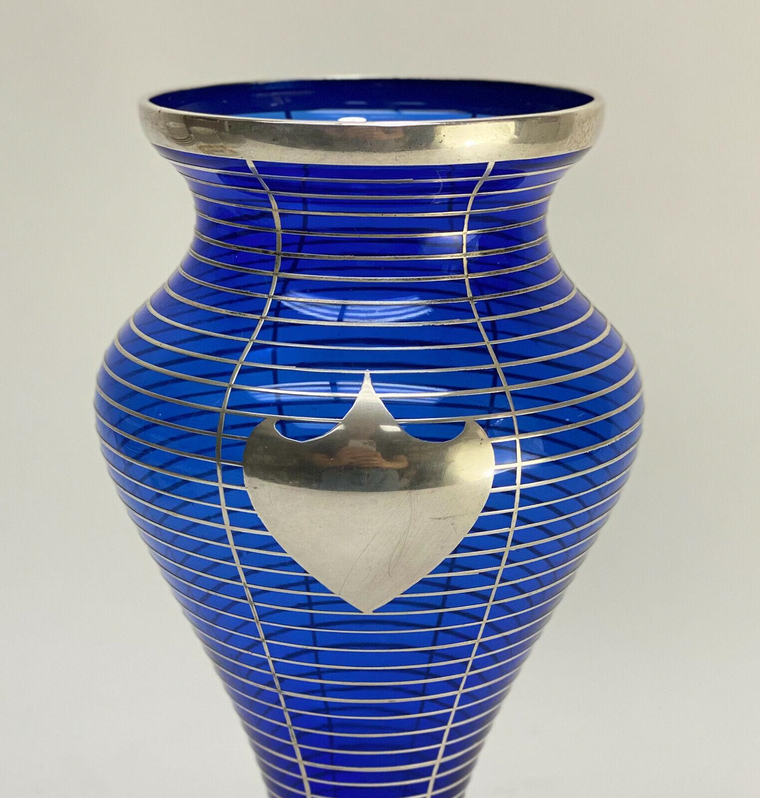 American La Pierre silver overlay cobalt blue glass vase, circa 1910

Vertical and horizontal silver stripes with an open monogrammed armorial crest to the center. La Pierre sterling silver mark to the base.

Additional information:
Time Period