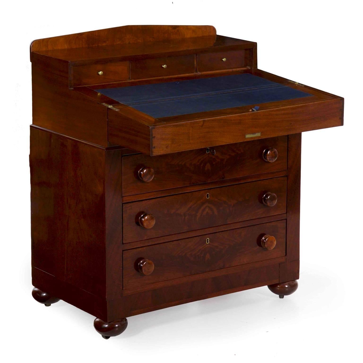 This beautiful case piece is dressed in the most vivid crotch-mahogany veneers, these showcased particularly well in the drawers and the edge of the closed writing slope.  This opens and rests on itself to create a stable writing surface for