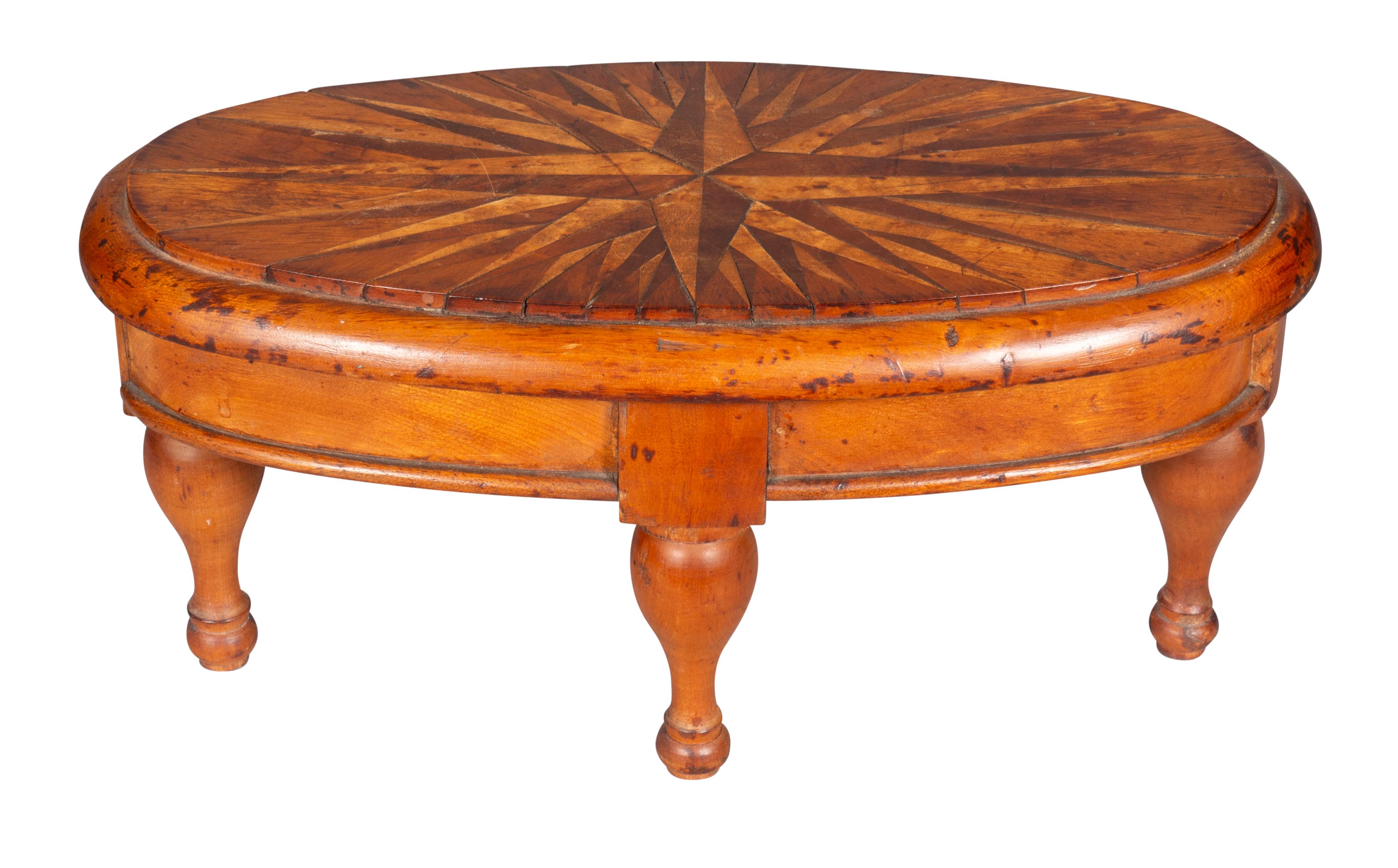 A nice table with oval top with compass inlay. Raised on turned legs.