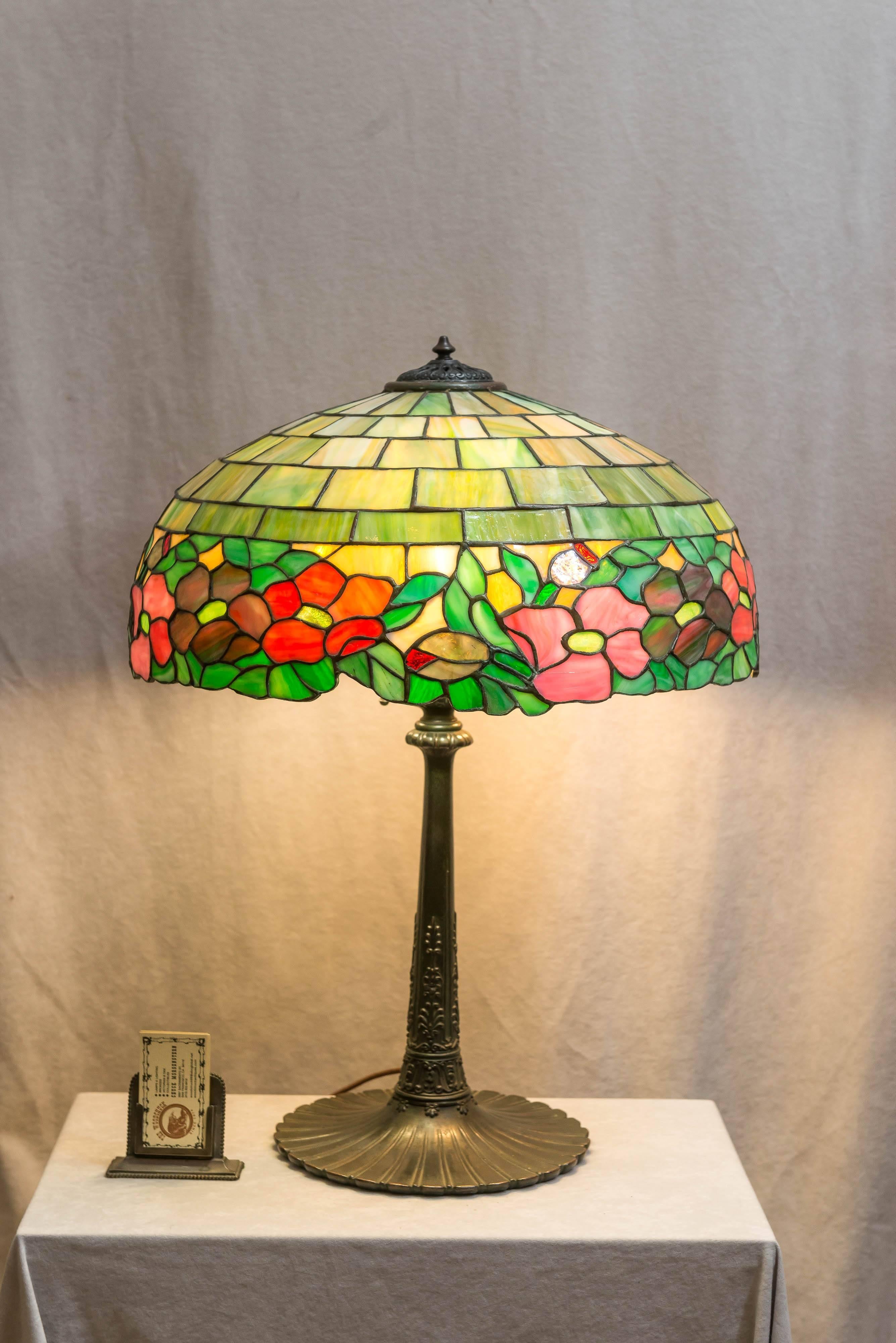 This highly colorful lamp was produced by the Wilkinson Co. circa 1912. For a similar lamp please consult 