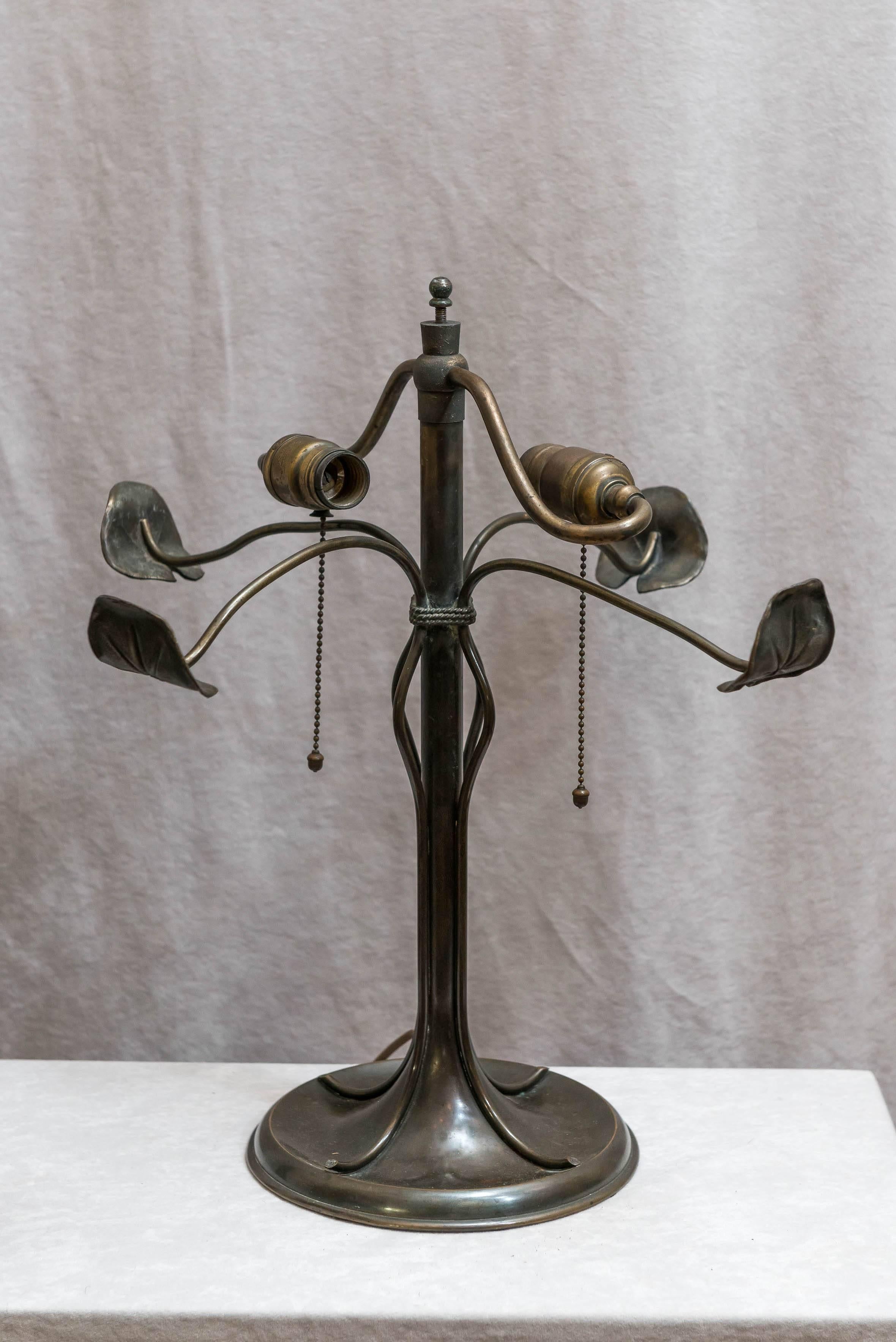 This lovely table lamp is quite unique. The Art Nouveau base is rather special, and is signed under the iron weight with the Bradley & Hubbard mark. The shade is very colorful with the dramatic red tulips. A very nice original package.