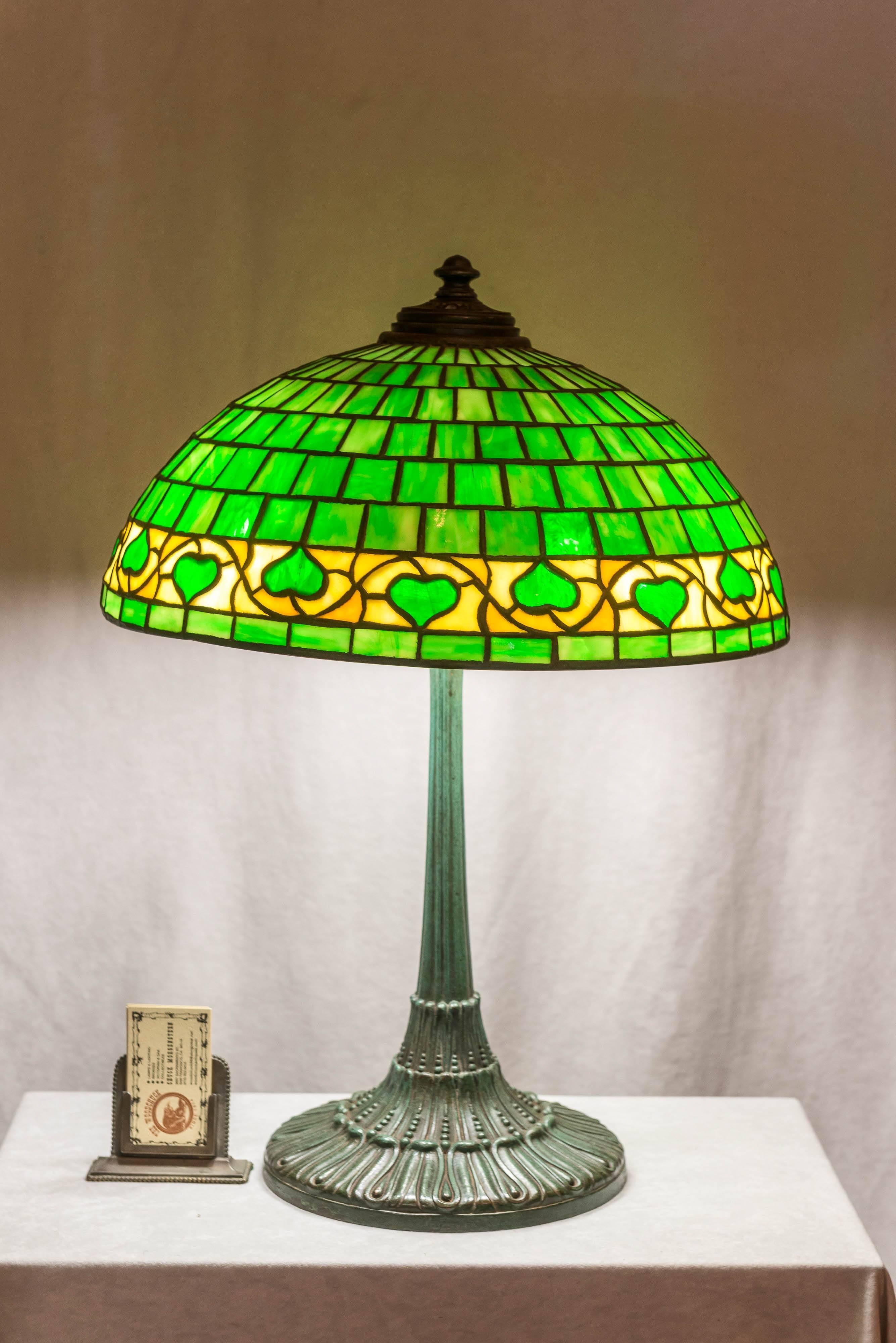 For the lovers of period stained glass lamps, here is a nice clean example. The shade is done in an acorn pattern and does copy the work of Tiffany who made a similar shade. The base is very beautiful, a characteristic of Wilkinson lamps. For a