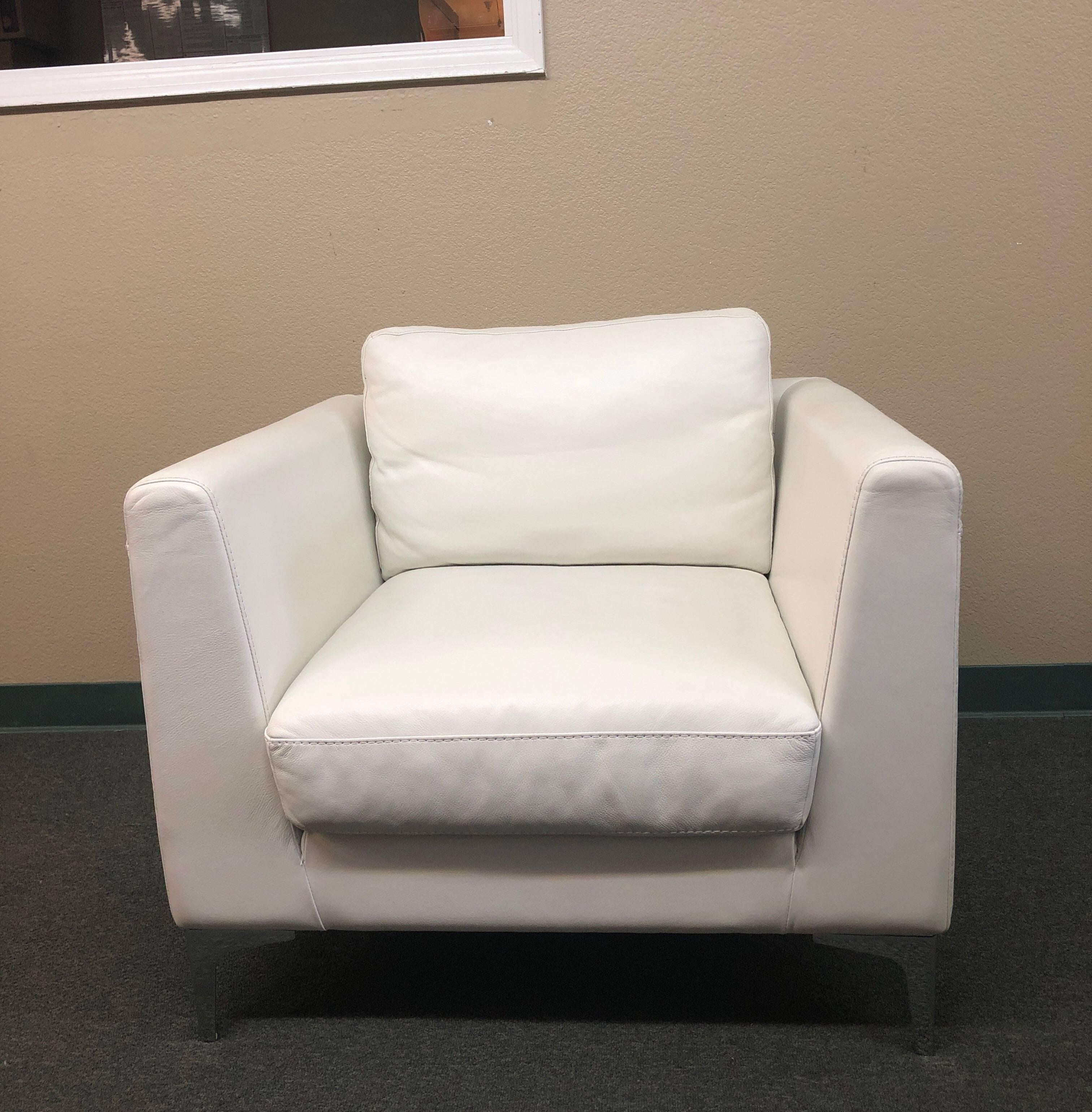 A design within reach Albert armchair in white leather. Manufactured by American leather for design within reach. The chair sits on chromed metal legs. They are finished with top stitching detail. Measures: Arms height: 26.5 inches, seat height: 17