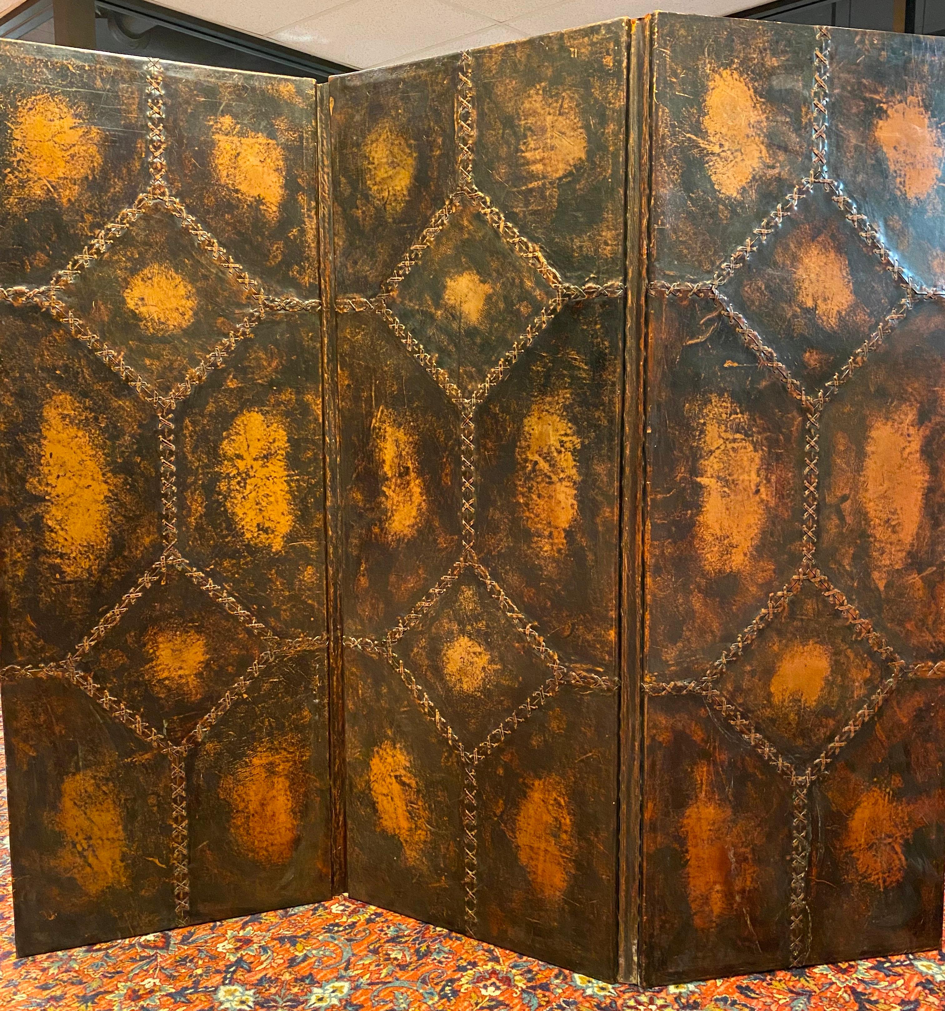 American three panel folding screen with leather surfacing, circa 1910.