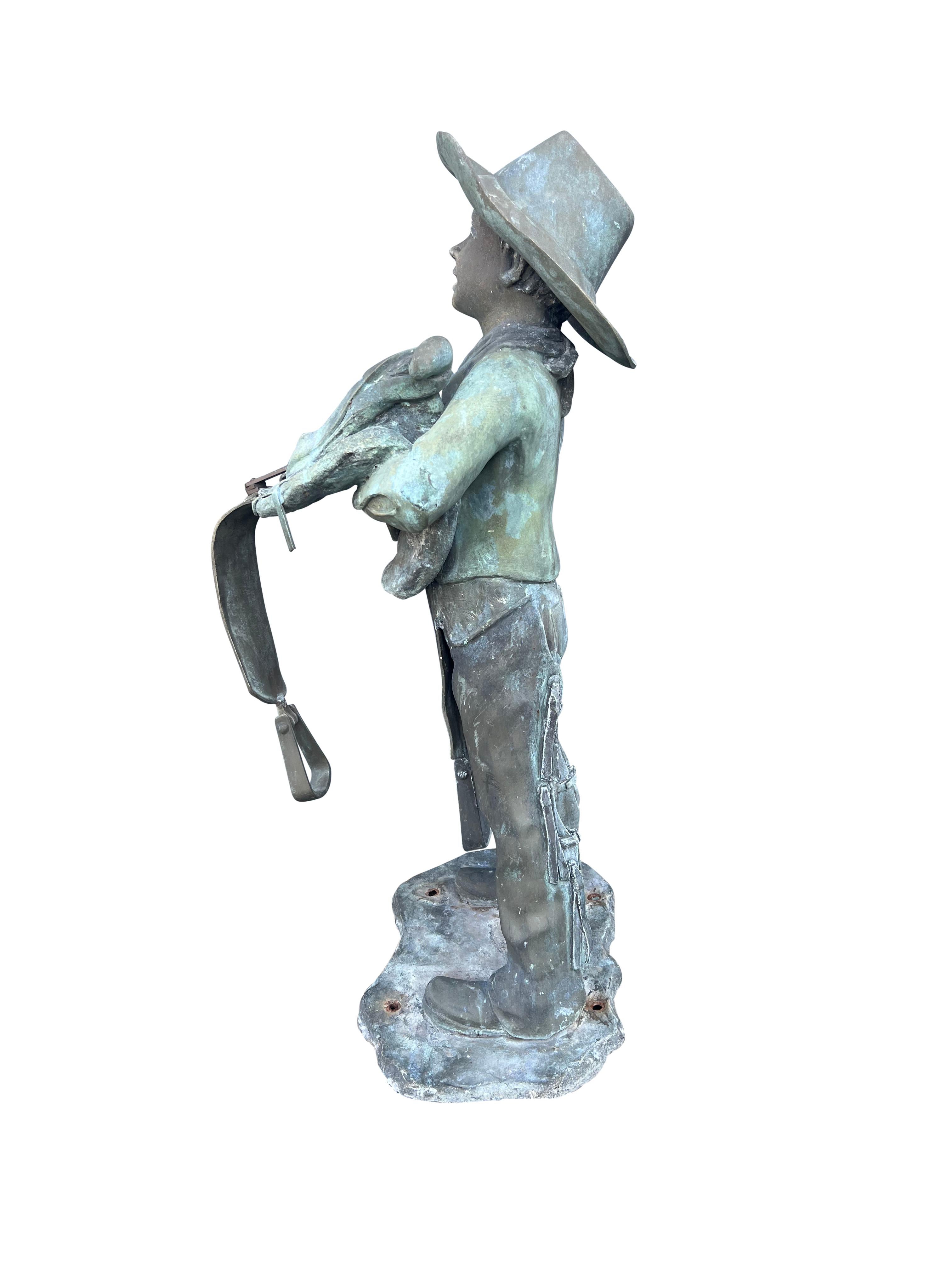 American Life Size Bronze of a Young Boy Holding a Saddle 1
