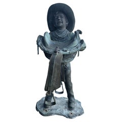 American Life Size Bronze of a Young Boy Holding a Saddle