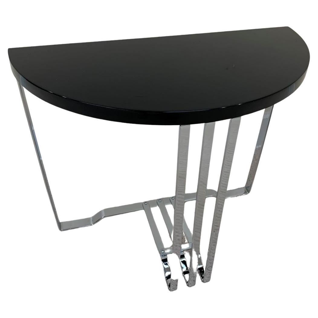 Machine Age Art Deco Half circle side table by Wolfgang Hoffman for the Howell Company circa 1930’s. Beautifully constructed of flat band chrome plated steel with an ebonized wood top. Last photo depicts the two-shelf model out of the 1935 Howell