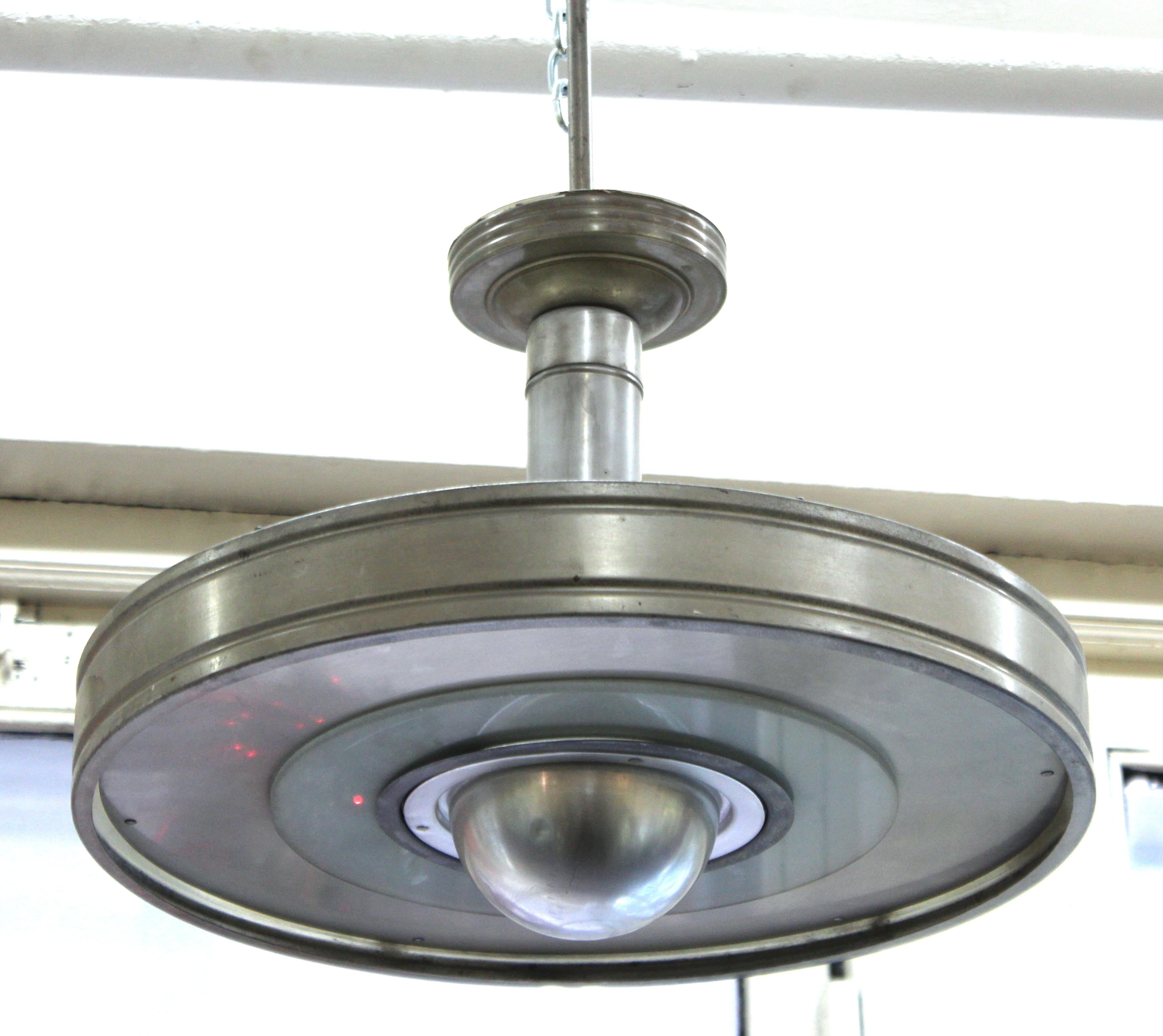 American Machine Age period ceiling pendant light made in metal and opaque glass elements. The piece was likely made in the United States during the 1930s and is in great vintage condition with age-appropriate wear.