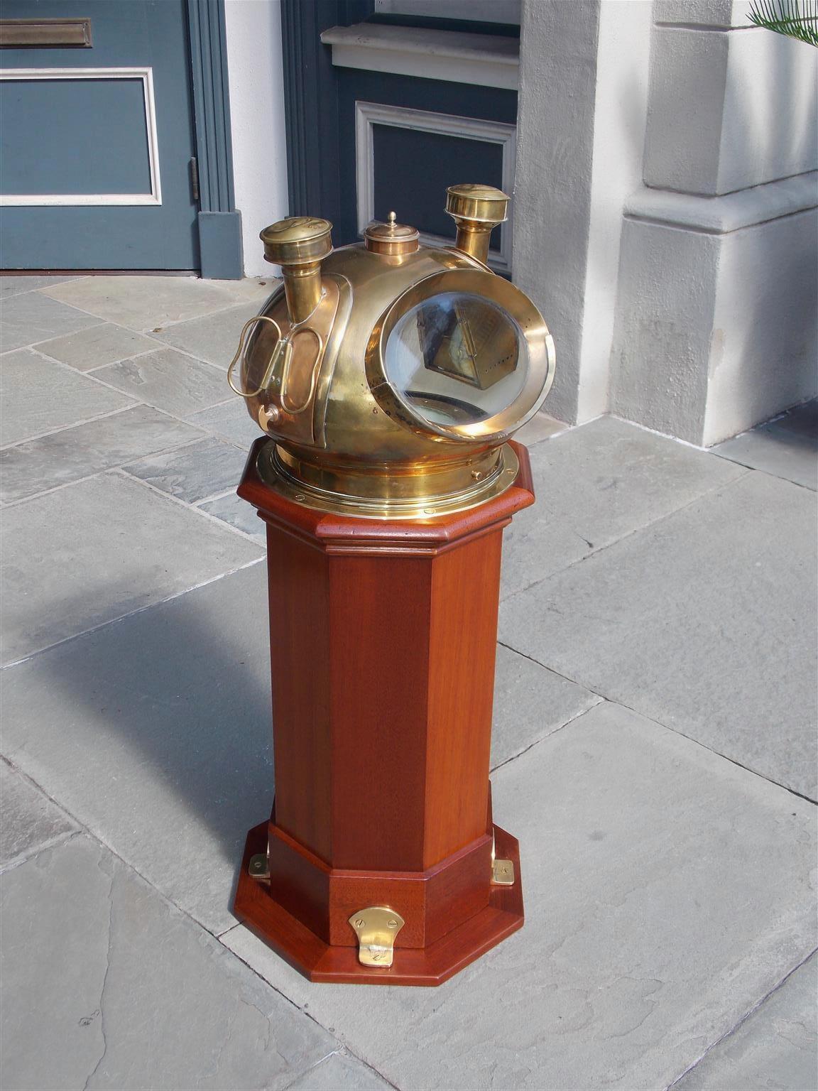 American mahogany ship binnacle with a brass-mounted dome helmet, internal dry compass by Ritchie of Boston, flanking removable burners with the original fonts and resting on an octagonal brass-mounted base. Binnacle maker Riggs & Brothers of
