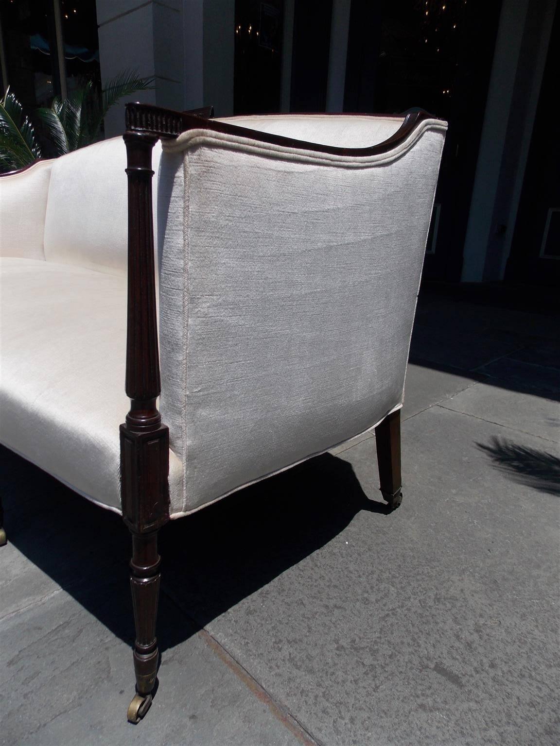 Hand-Carved American Mahogany Sheraton Style Upholstered Sofa on Brass Casters. Circa 1880