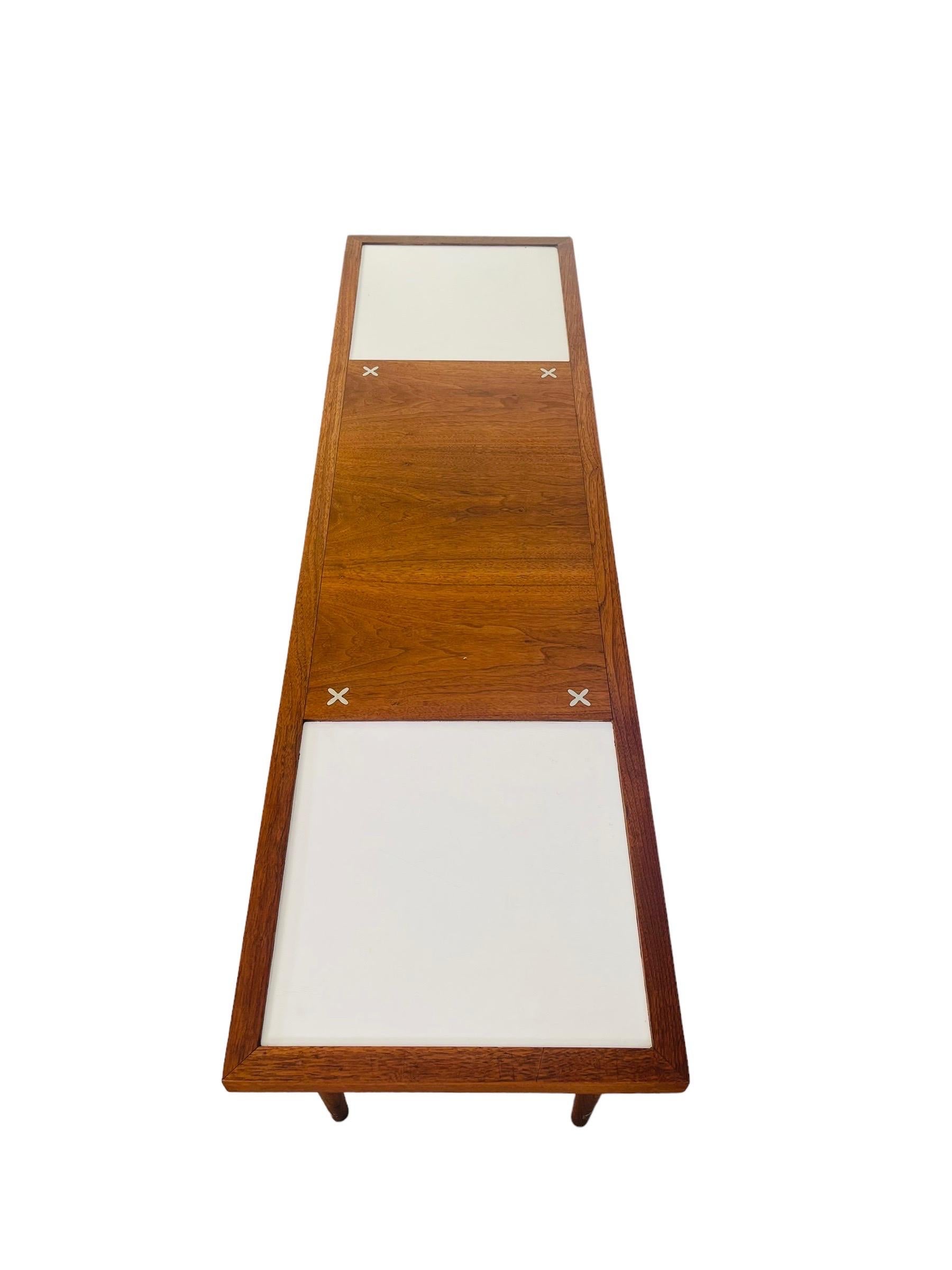Mid-Century Modern walnut & laminate coffee table with 6 gorgeous tapered legs by American Martinsville. This X-Line is widely popular because of the four X inlay on top. This beautiful table has two square white laminate cube on each end which adds