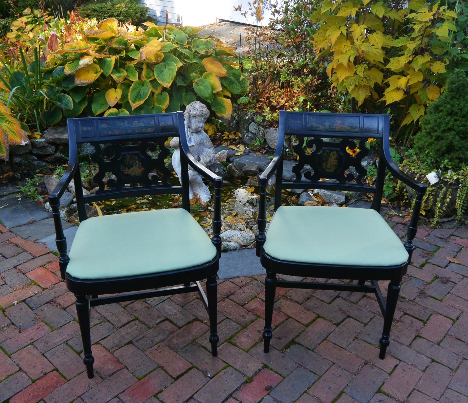 American Sheraton pair of mid 19th century armchairs, repainted in black with original chinoiserie decoration undisturbed.  This pair of chairs has had the slip seats replaced circa 1911 and have recently been reupholstered in celadon green.  The