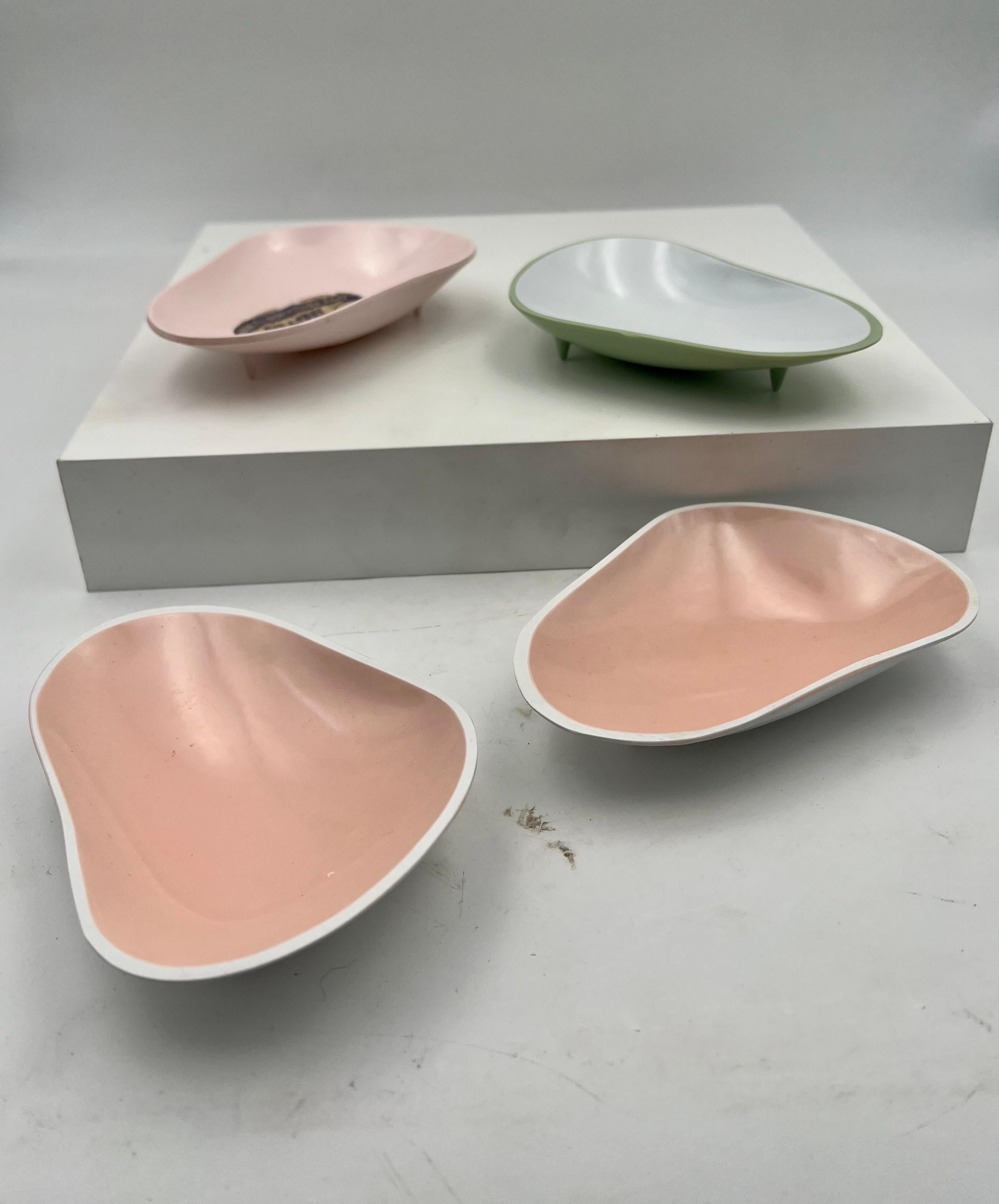 Great set of 4 new never used freeform snack trays, circa the 1950s in melamine, with beautiful pastel colors, and shaped one has the original sticker which we left but easy can be removed and also comes with 3 little feet.