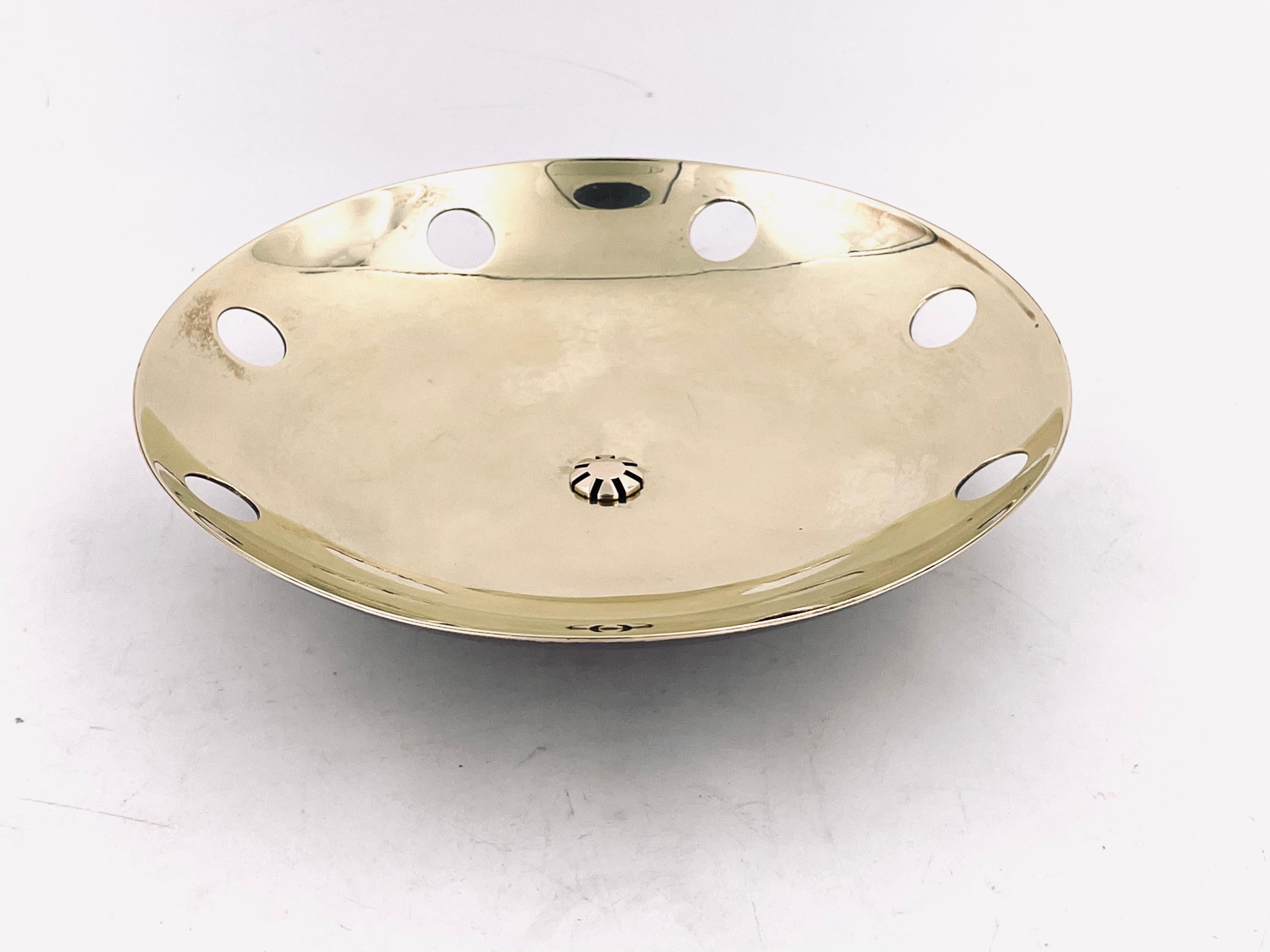 A rare centerpiece solid brass perforated polished brass with footed base circa 1950s made by Buenilum brass company. We polished the top and left some patina in the bottom.