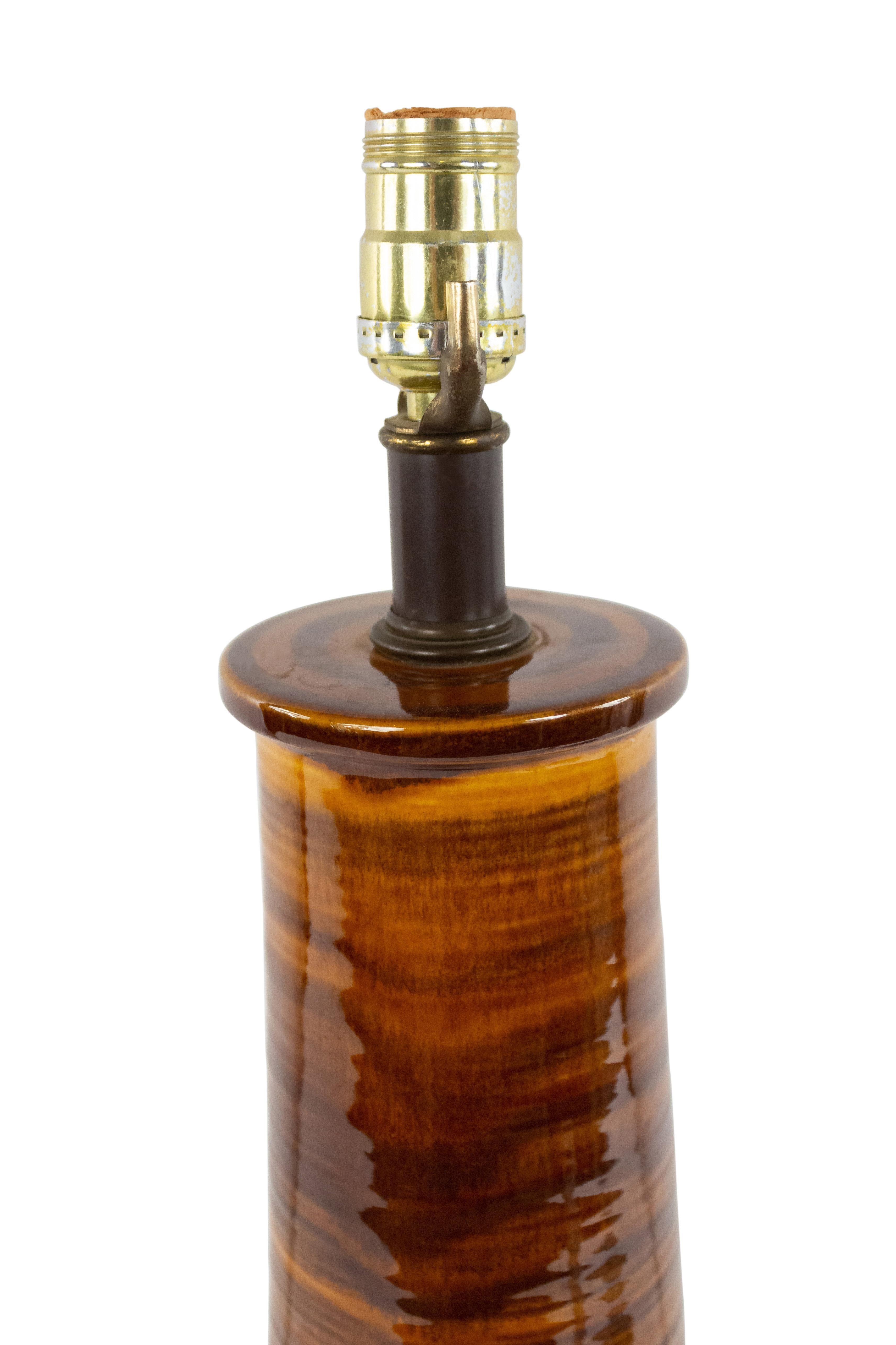 American mid-century brown and black striated cylindrical 2 tier table lamp with a brown metal round base.