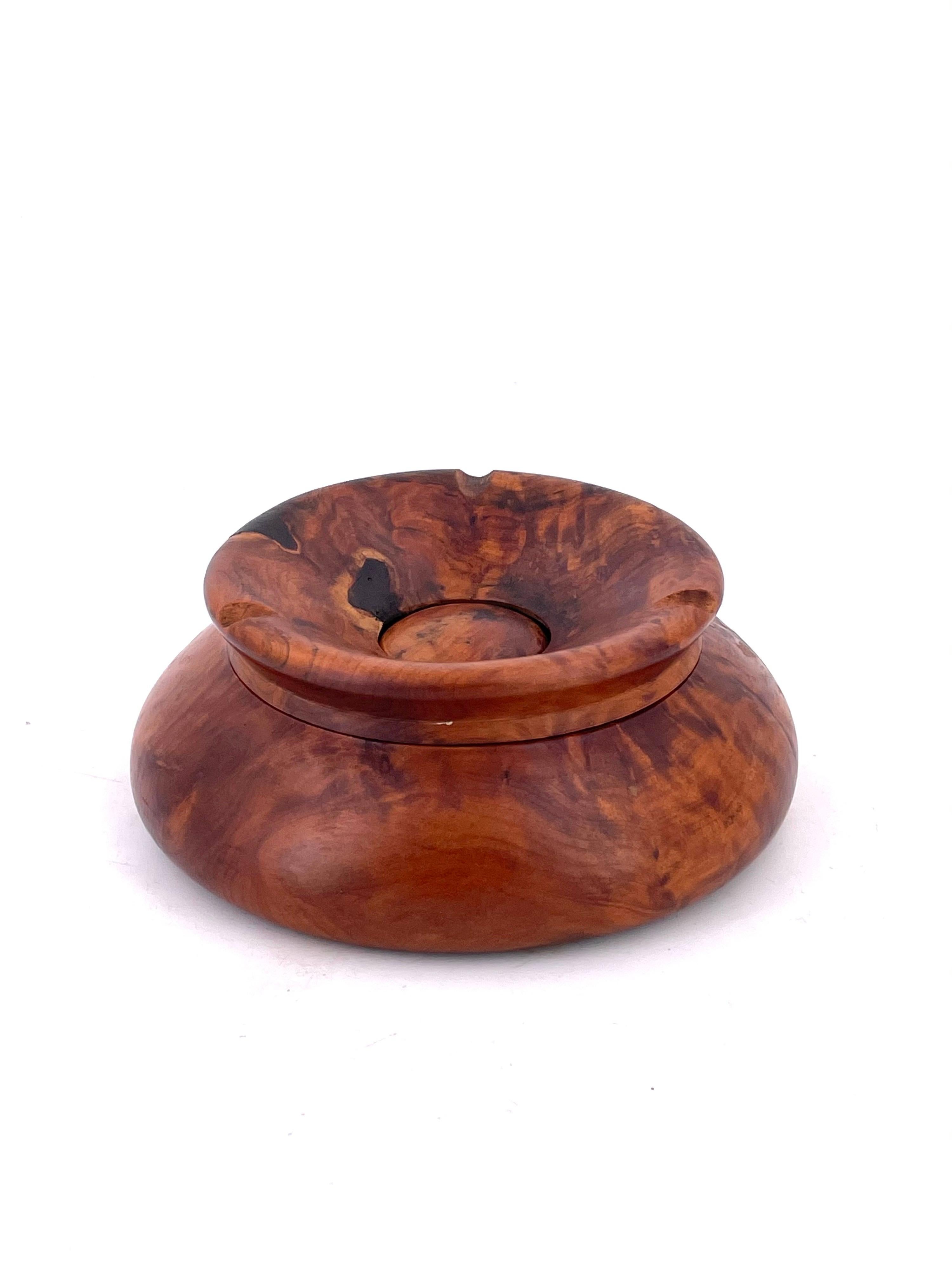 A beautiful piece of hand carved burlwood ashtray with a removable top to keep the fumes inside natural wear due to age.