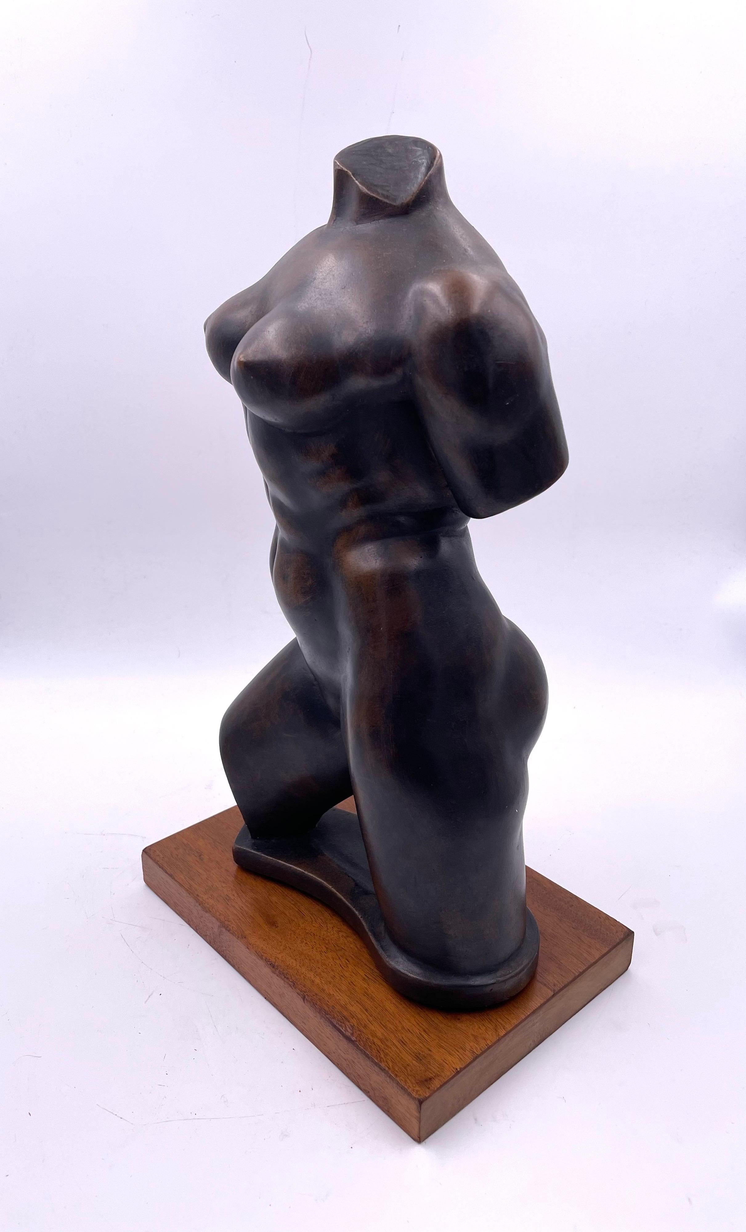 Beautiful reproduction of a nude bust in a patinated bronze finish sitting on a solid walnut base, circa 1950's by Austin productions. Made of ceramic and faux bronze finish.