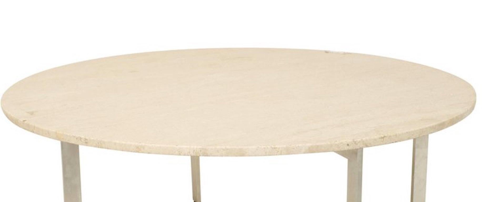 American mid-century round coffee table with travertine top resting on a four-leg chrome base.

 