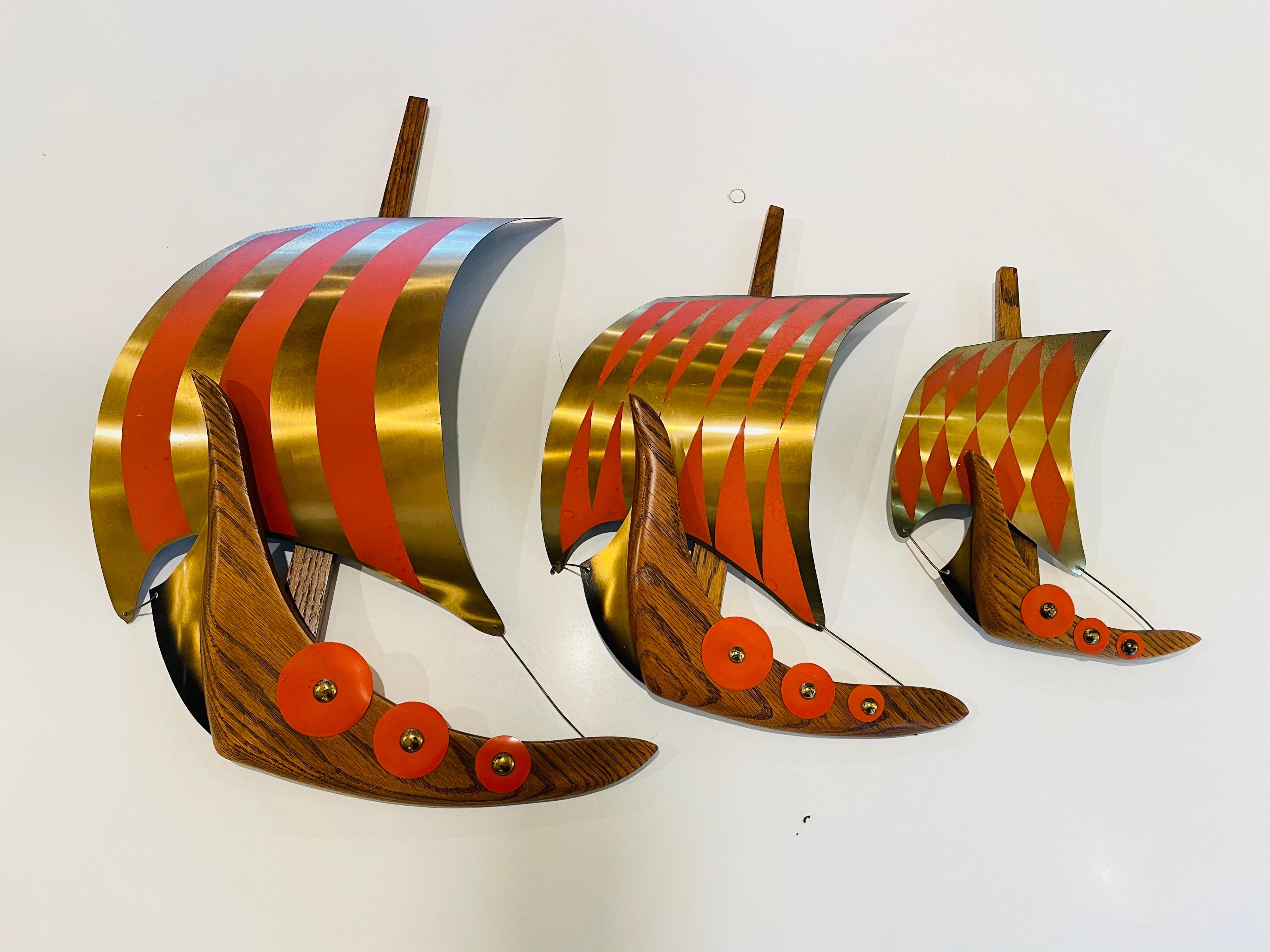 Beautiful and rare set of 3 Viking ships, circa 1950s very nice and clean condition brass sails painted in orange with oak frames the largest ship its 22