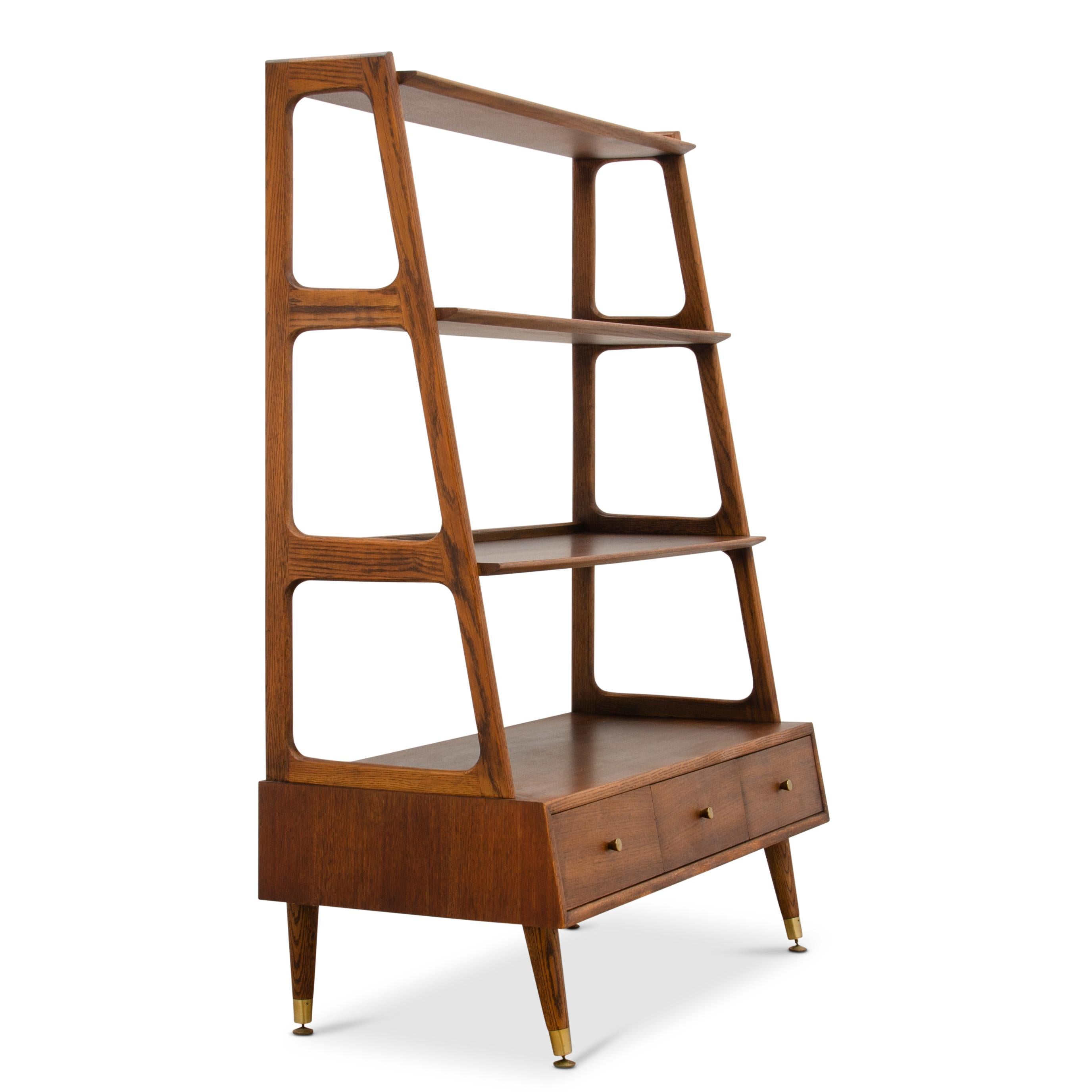 An American Modern bookshelf or display cabinet. Unmarked. It is well made of oak and walnut with dovetailed drawers and brass feet. The height of the top shelf opening is 12