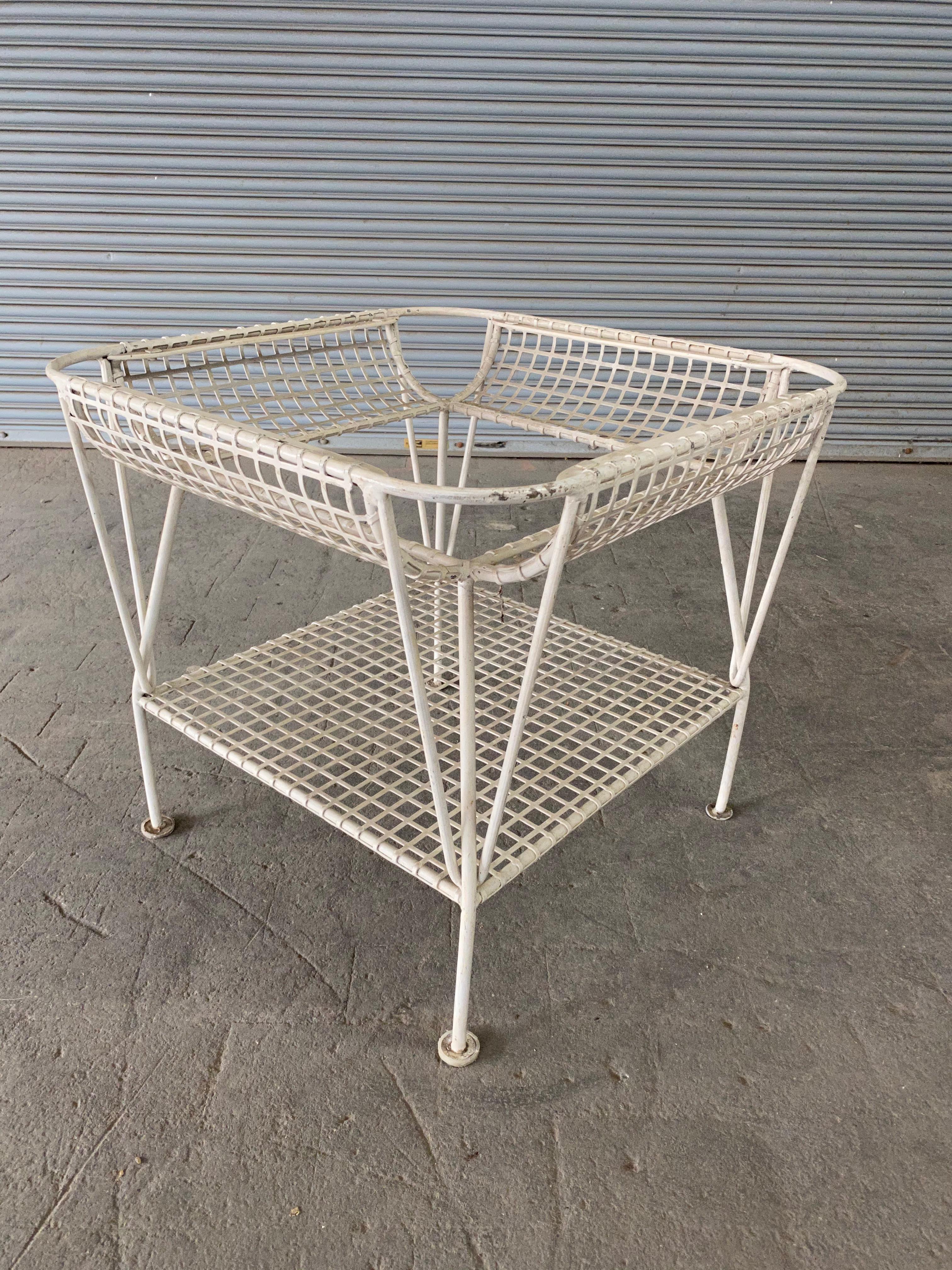 American Mid-Century white iron end table with glass top.  This table is part of a larger set that includes a 3 piece sectional settee, an armchair as well as a dining table and 4 chairs. All sold separately.

 