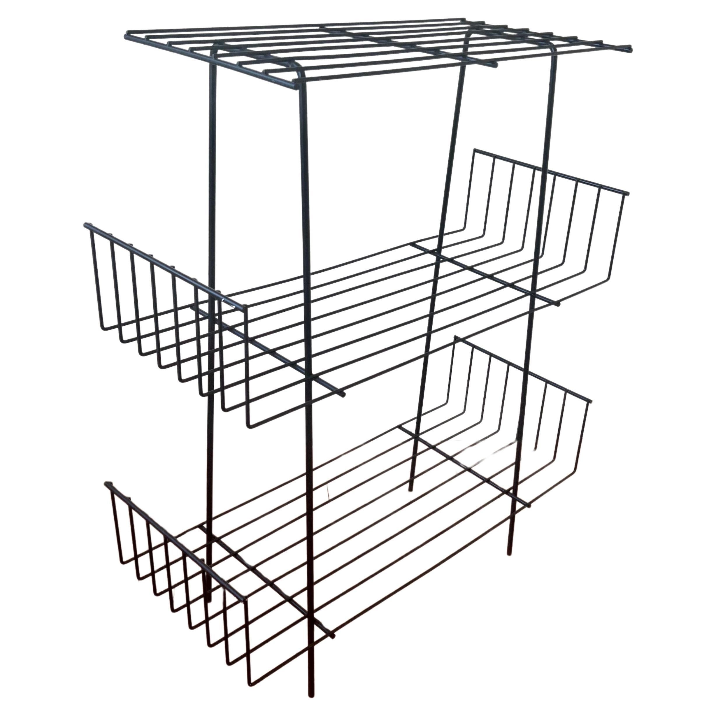 American mid century iron triple shelf stand /rack by Tony Paul.

Tony Paul studied at Brooklyn Polytechnic and majored in design at Pratt Institute. Before volunteering for Armed Service, he worked for five years on commercial and residential