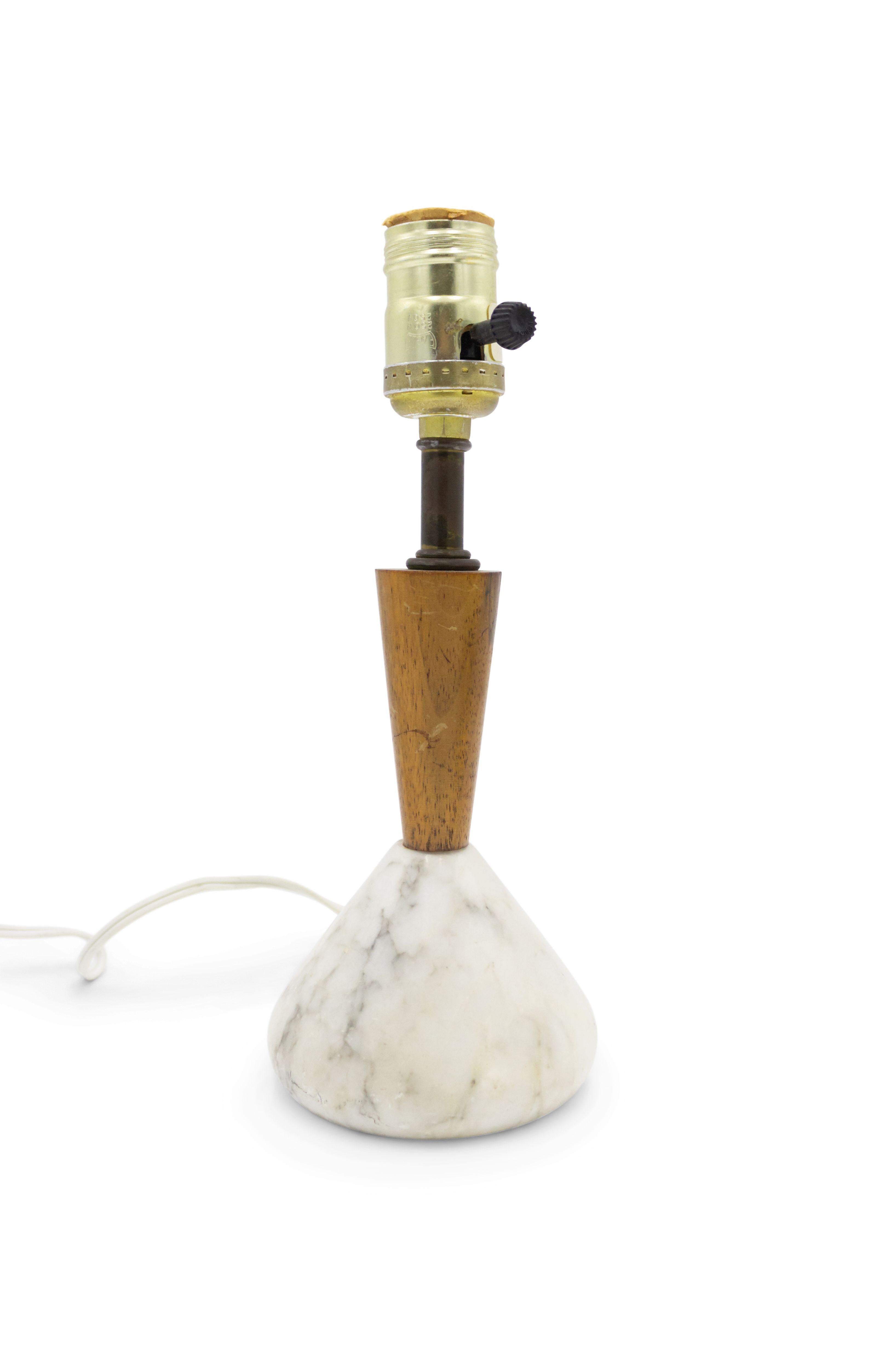 American Mid-Century (1960s) small table lamp with a white marble cone shaped base over a tapered teak neck supporting a lamp shade.