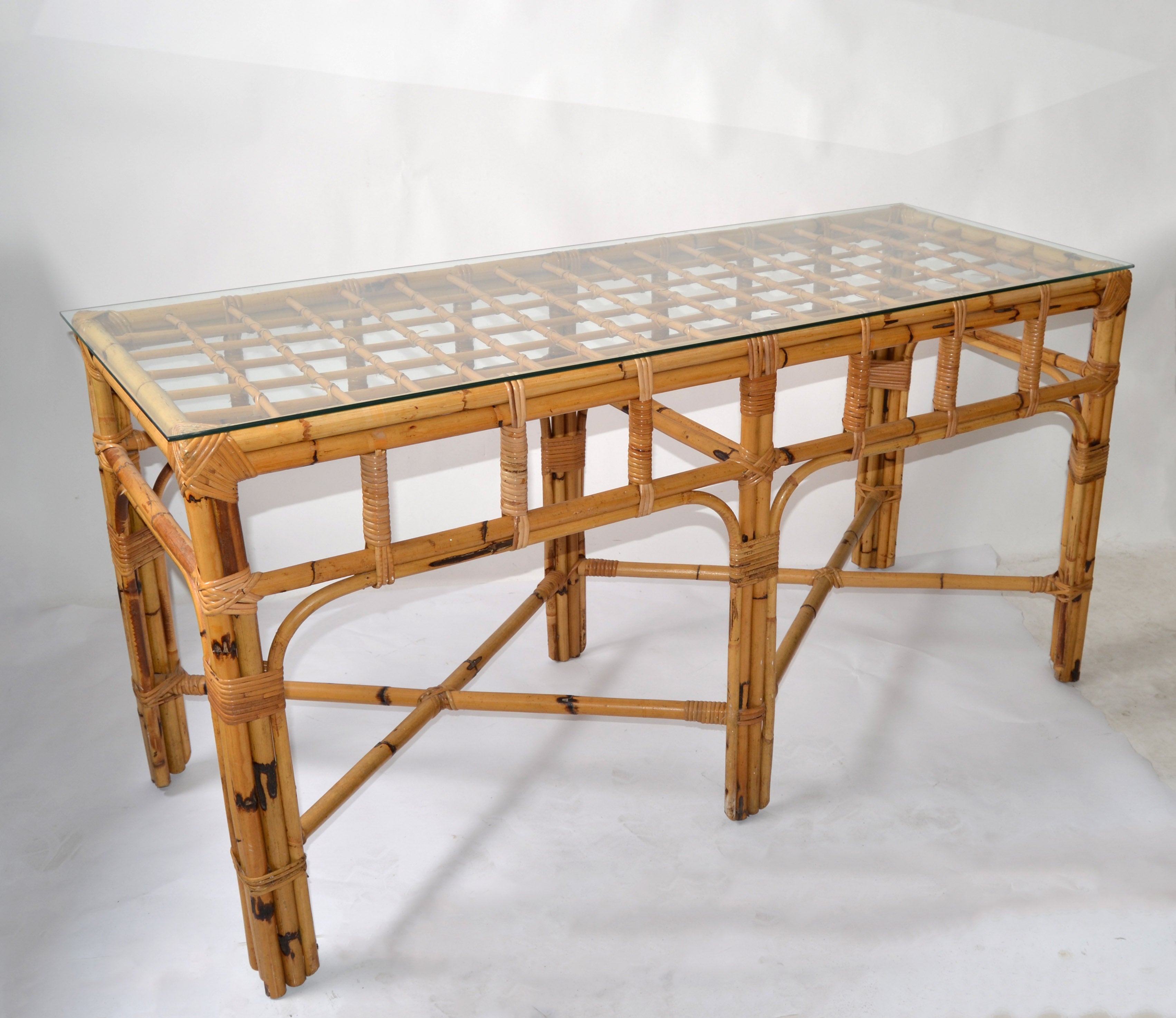 Stunning Boho Chic Mid-Century Modern handcrafted console table or sofa table in bent bamboo and rattan bindings.
Unique six bamboo legs and detailed handwoven corners and X Stretchers.
Comes with a glass top.
Console measures without the Glass