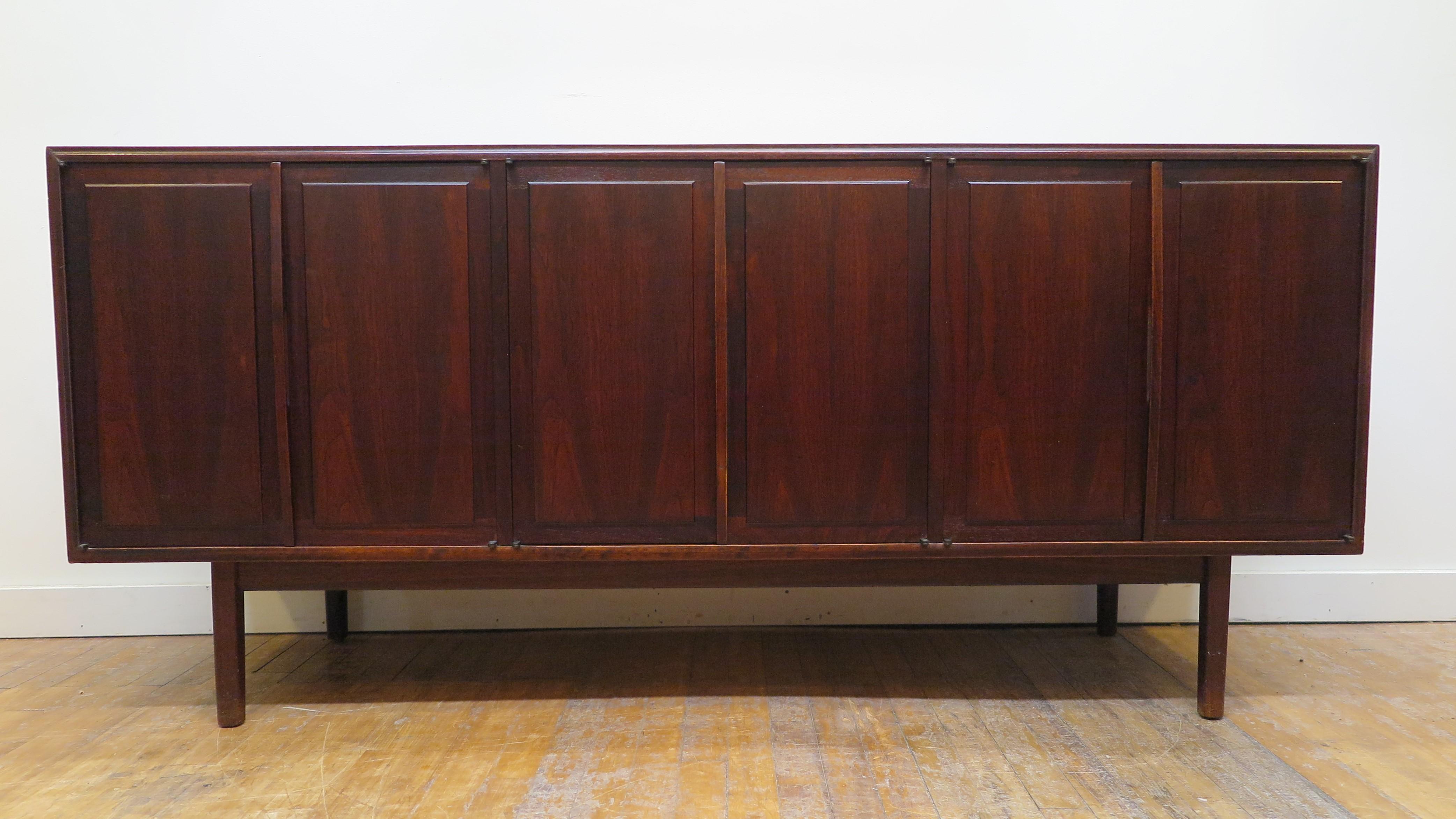 American Mid Century Modern Walnut credenza sideboard by Jack Cartwright for Founders 1962.  Having Three compartment cabinets with three drawers and three shelves. In good condition with a nice patina. The top has some fading and light wear nothing
