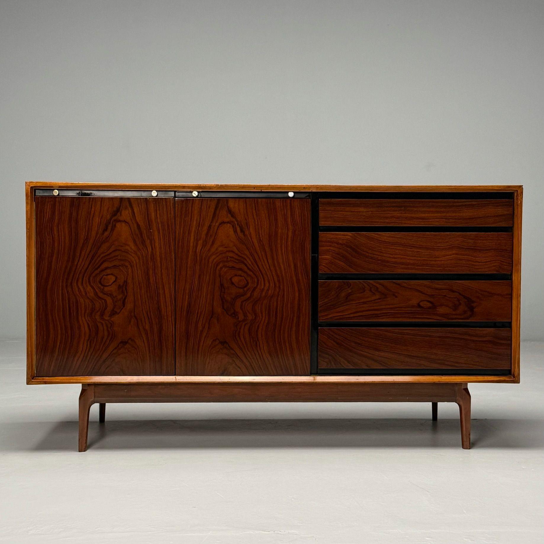 American Mid-Century Modern, Credenza or Sideboard, Rosewood, Walnut, 1950s

This modern cabinet features a walnut frame that provides a warm, sophisticated aesthetic. It is designed with two swing-out doors for easy access to the interior,