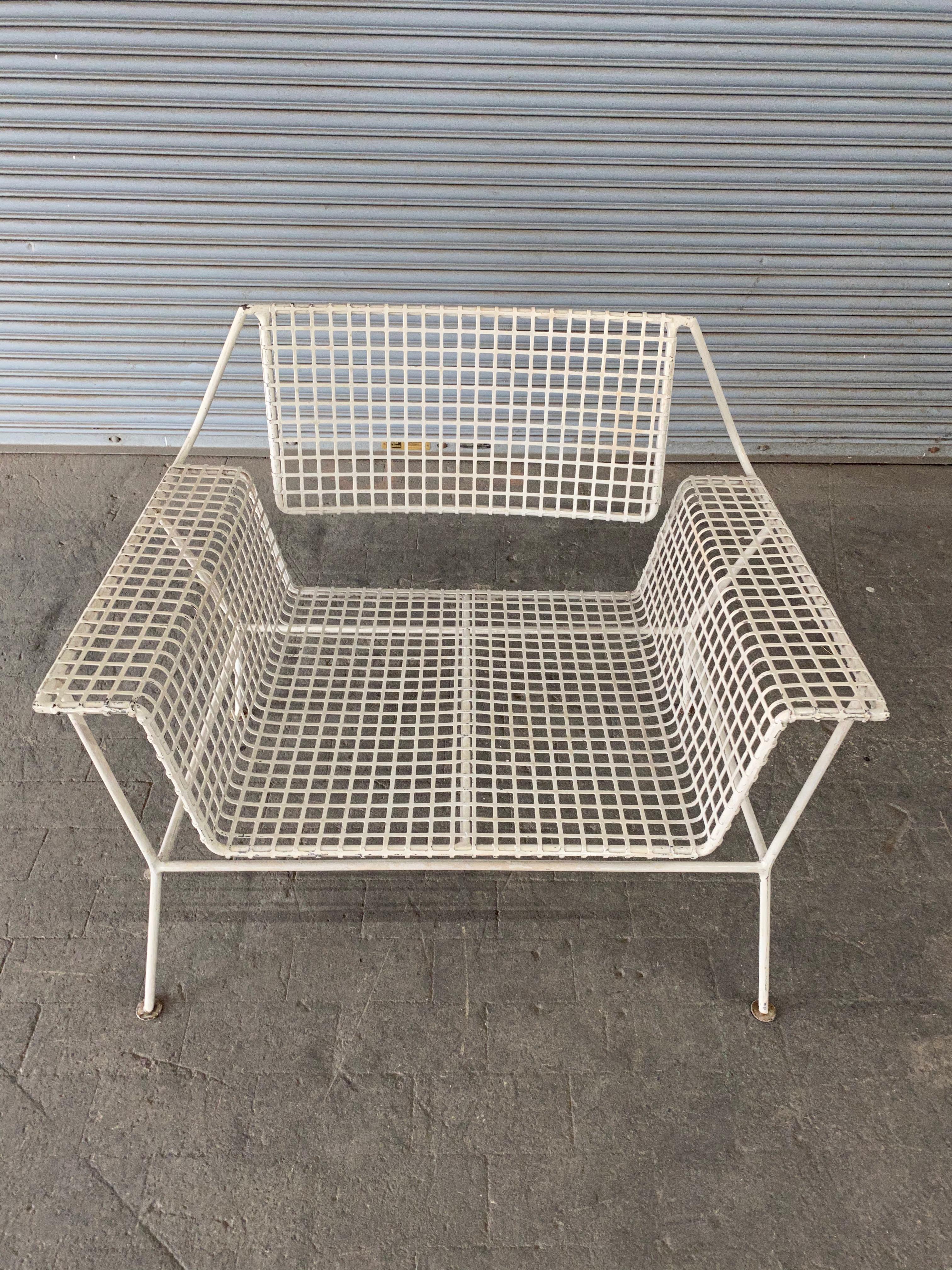American Mid-Century Modern white iron garden armchair. Part of a larger set that includes an armchair, a three piece settee, and an end table. 


