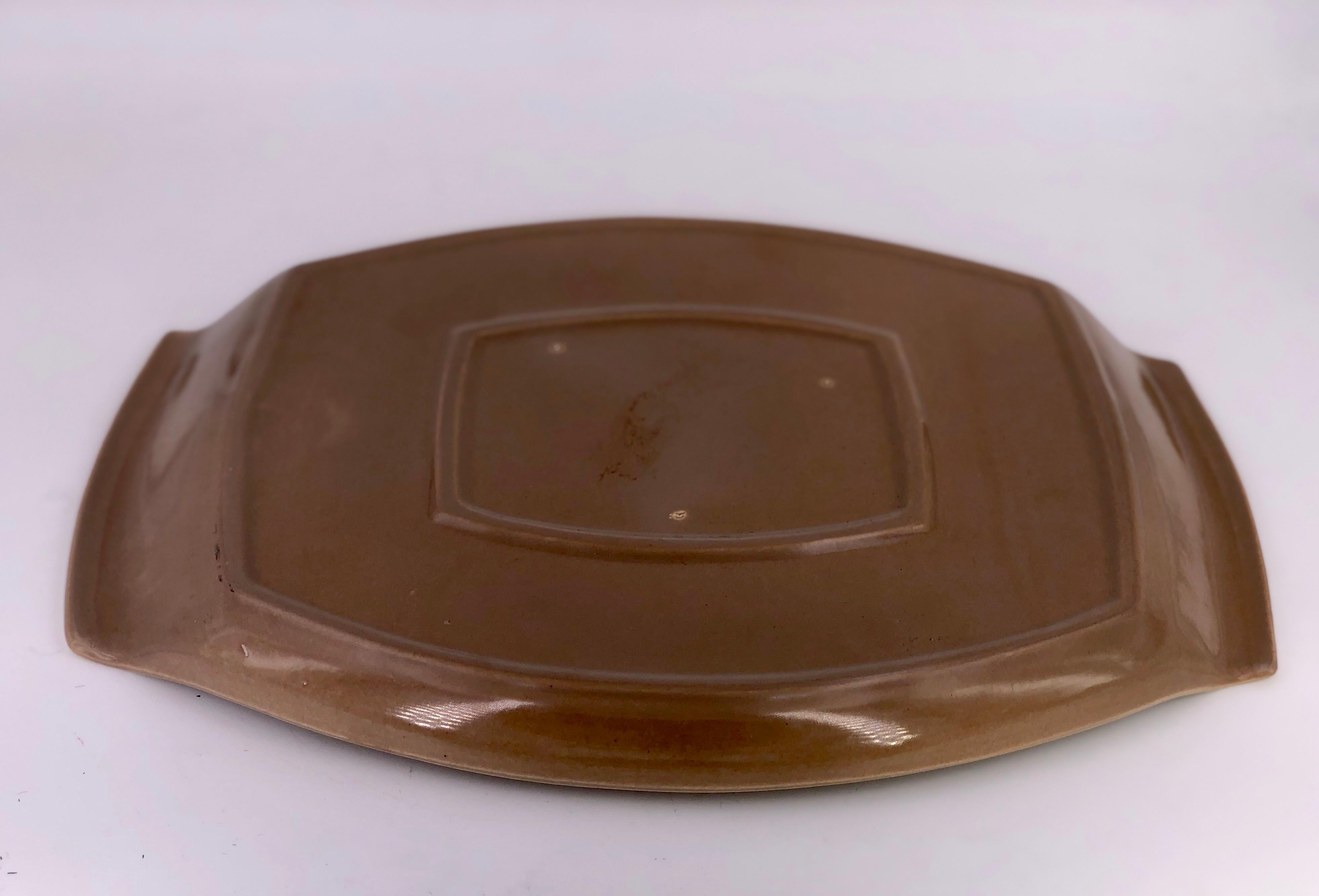 A beautiful large oval centerpiece plater with handles designed by Aldo Londi for Red Wing Pottery. Classic midcentury design.
