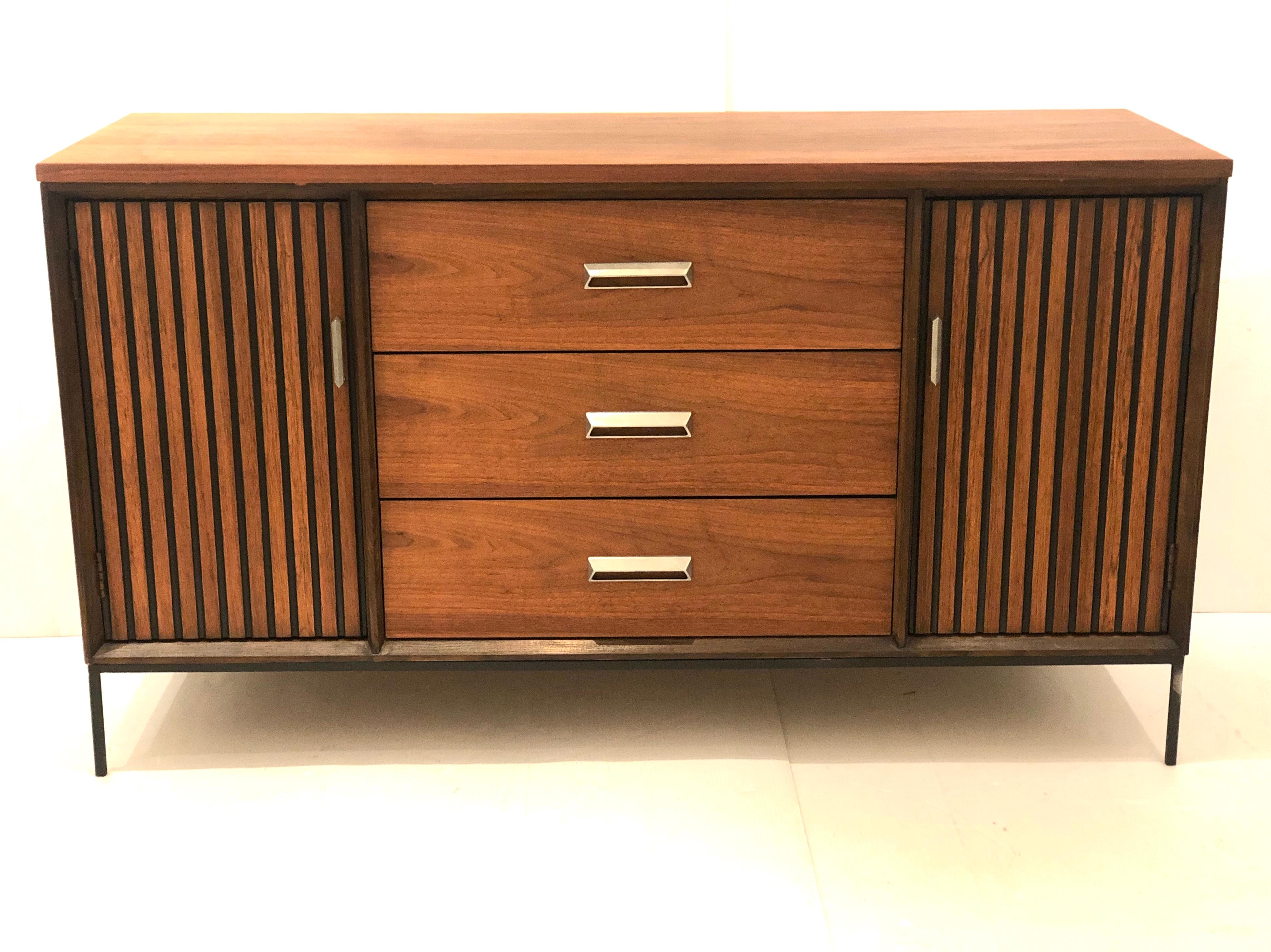 Simple well design small Mid-Century Modern walnut credenza, circa 1950s with solid iron black painted base , this piece has been refinished and hand rubbed oiled, some natural imperfections a small stain on the top as shown, nothing major but needs