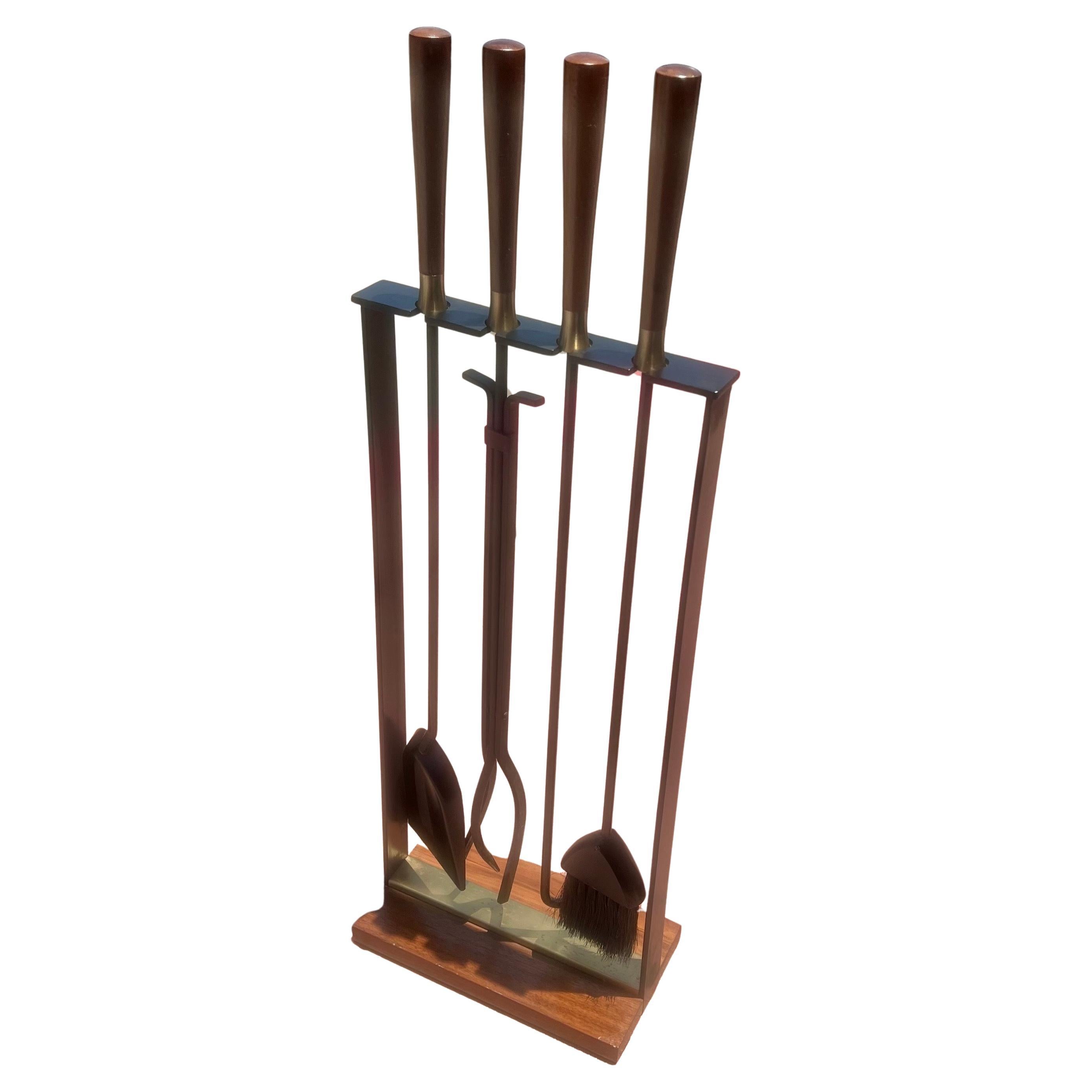 Solid iron fire tools set in black enameled finish with a nice patina in original condition. can be used indoors or outdoors. Solid walnut handles with brass accents , very rare set designed by George Nelson for Pilgrim great for Danish Modern Mid