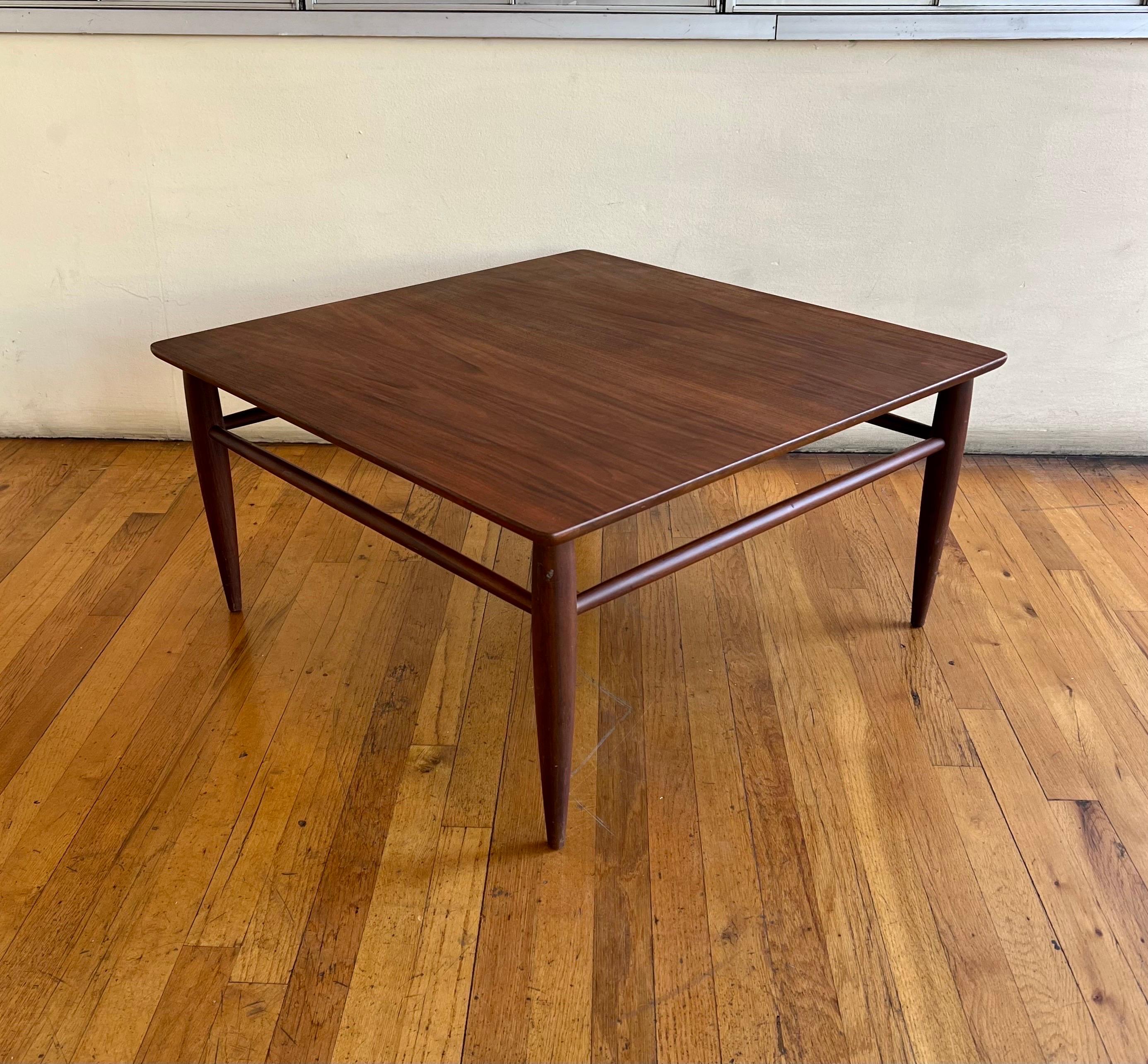 Mid-Century Modern square coffee table in walnut, circa 1970s. nice solid tapered legs freshly refinished top solid and sturdy.
 