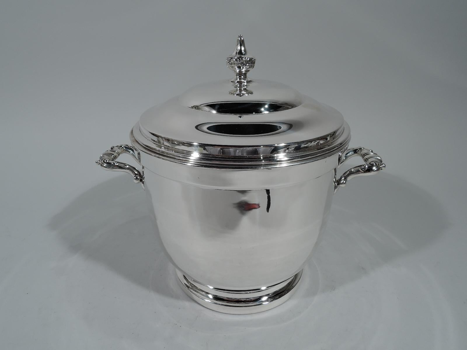 American Mid-Century Modern sterling silver ice bucket. Made by Poole in Taunton, Mass. Urn form on stepped foot. Double-domed cover with tooled vase finial. Ornamented bracket side handles. Indian chief in native headdress and beaded buckskin coat