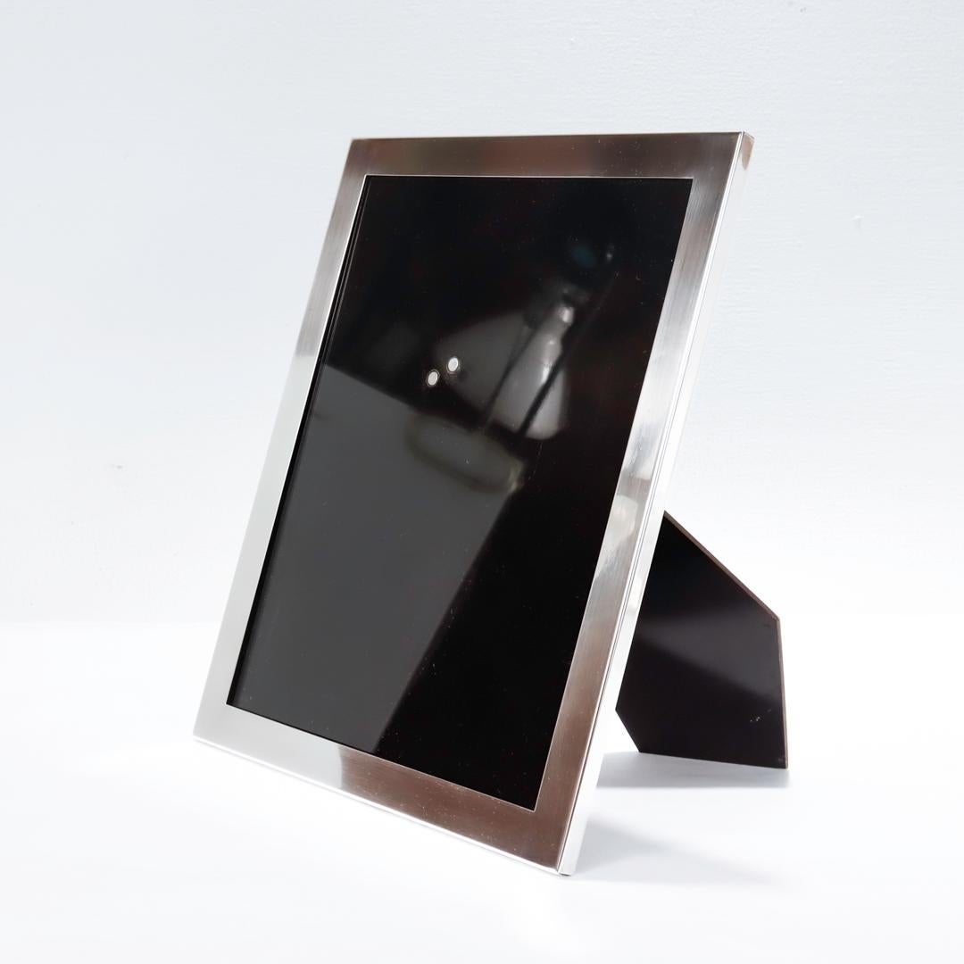 A fine American Mid-Century photo or picture frame.

In sterling silver.

By Lebkuecher & Co.

Model No. 708

Supported by a sturdy, black laminated easel back.

Simply a terrific Modern frame!

Date:
Mid-20th Century

Overall Condition:
It is in