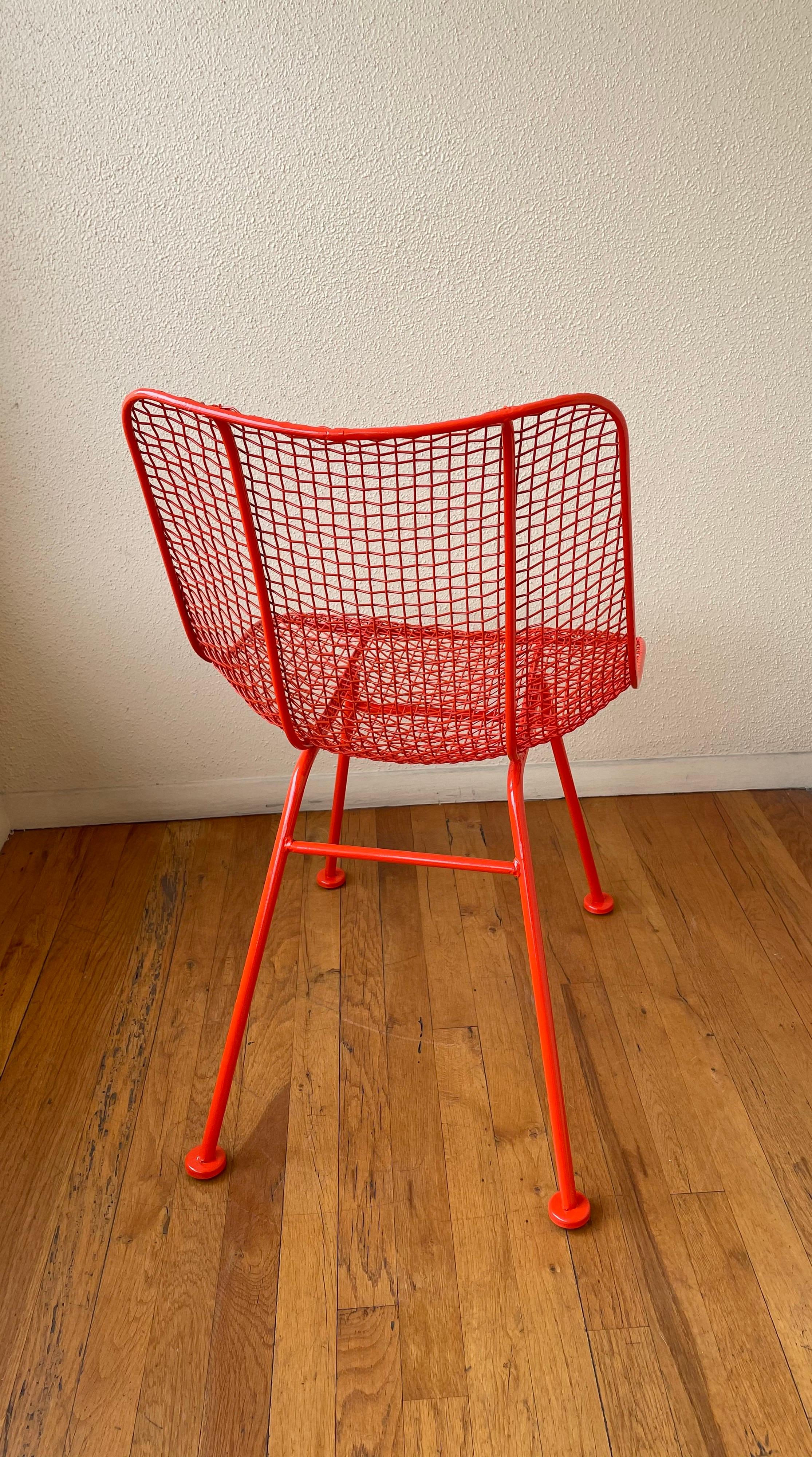 Designed in 1956 the solid iron chair part of the sculptura collection, by Russell Woodard we have this chair freshly powder coated beautiful orange-red finish, Sculptura is inspired by the airiness of wicker but handcrafted in sturdy iron mesh